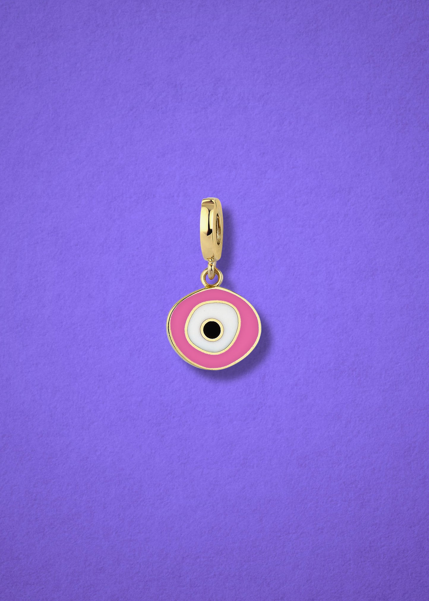 Blush Organic Evil Eye clip-on charm crafted in 14K solid gold with hand-painted pink, white, and black enamel detailing, shown on a lilac background.