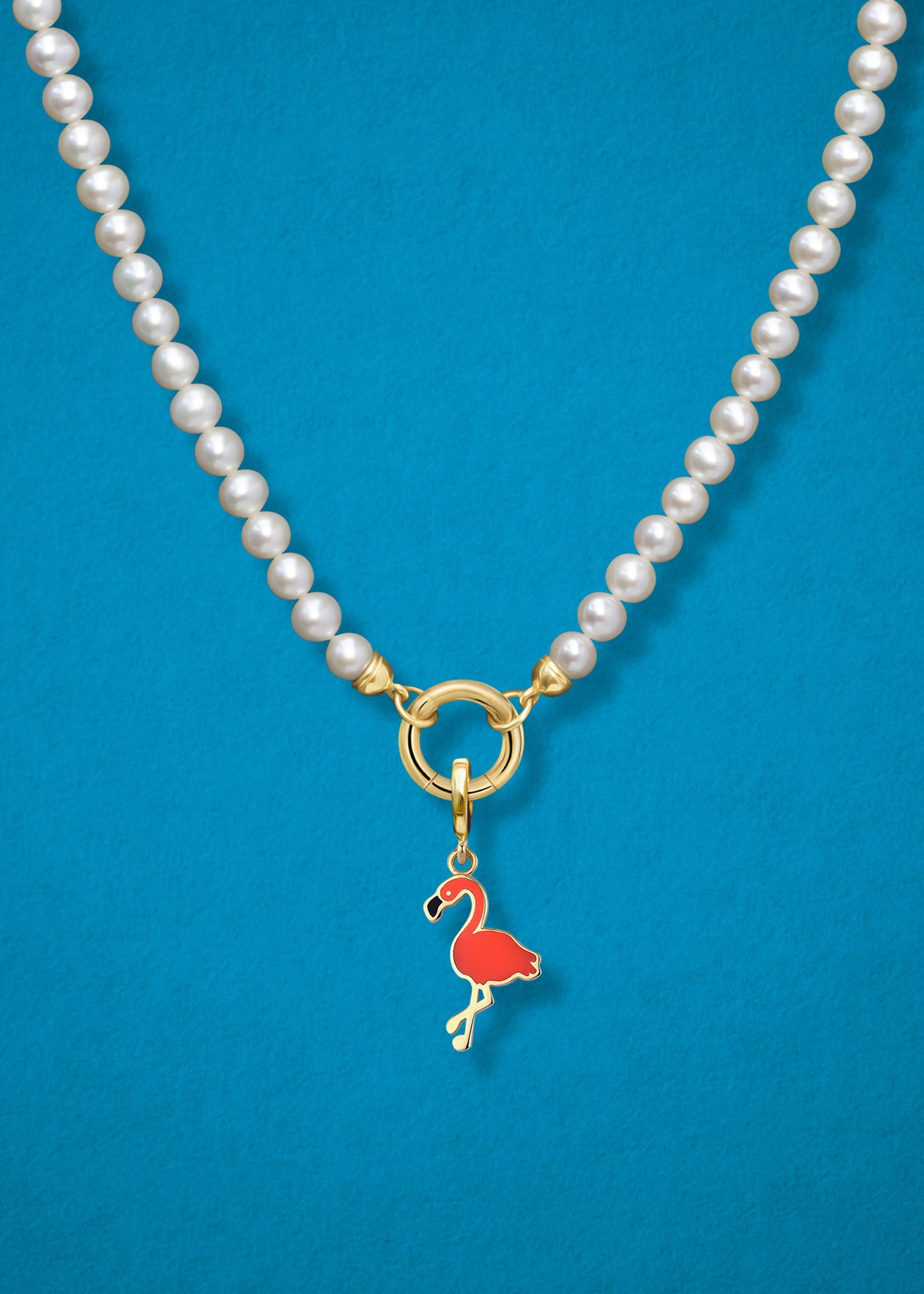 Close-up of the Flamingo Flair Charm paired with the Lustrous Pearl Charm Necklace by whywhy NYC, featuring 14K solid gold and freshwater pearls for an elegant and playful design.