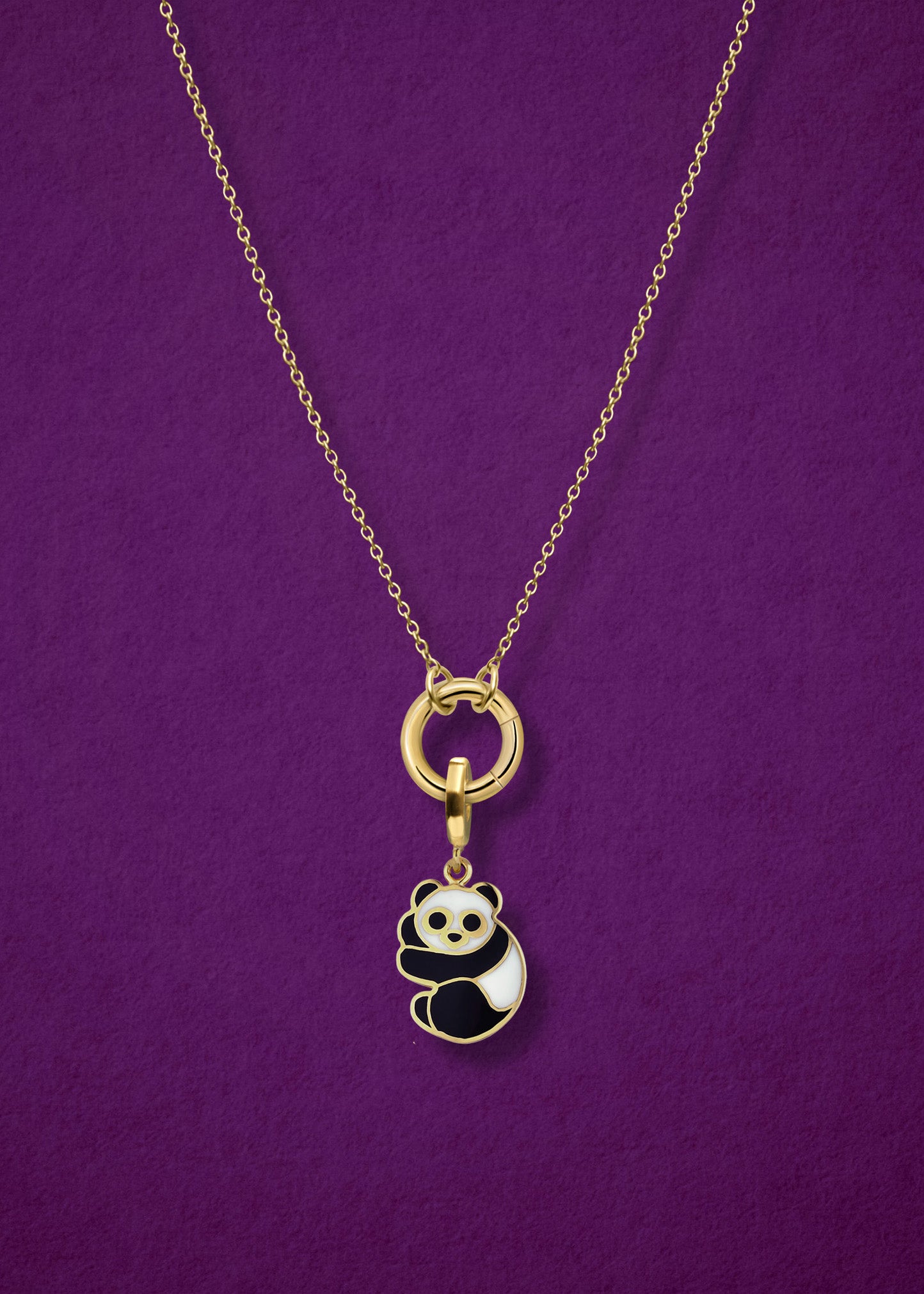 Close-up of the Golden Grace Panda Pals Charm Necklace, featuring a 14K solid gold cable chain, a golden link charm holder, and a panda pals charm with black and white enamel by whywhy NYC.