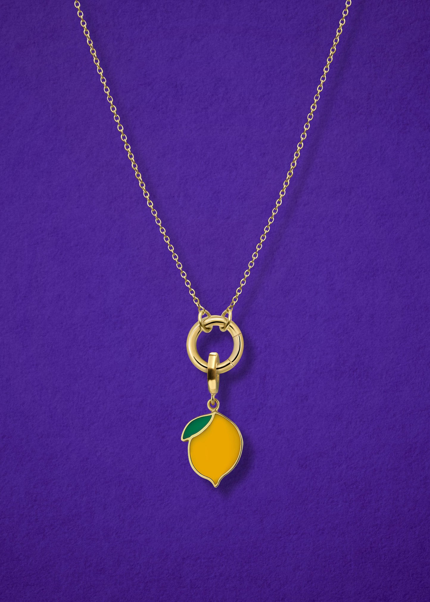 Close-up of the Golden Grace Zesty Lemon Charm Necklace, featuring a 14K solid gold cable chain, a golden link charm holder, and a zesty lemon charm with yellow enamel by whywhy NYC.