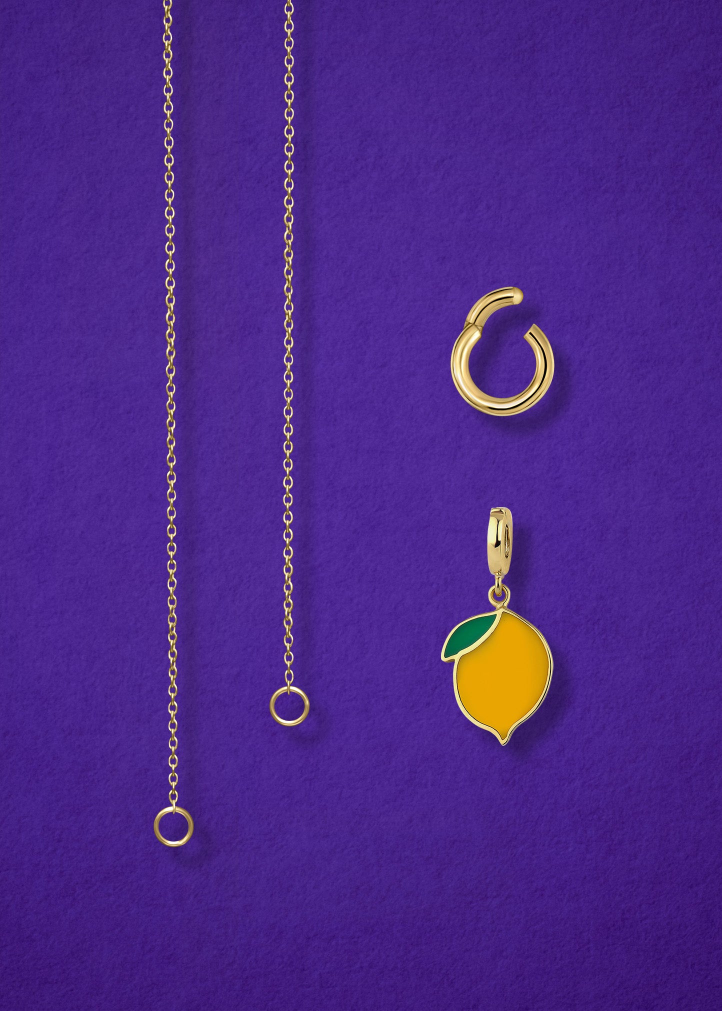 Close-up of the separated Golden Grace Zesty Lemon Charm Necklace components: 14K solid gold cable chain, golden link charm holder, and zesty lemon charm with yellow enamel by whywhy NYC.