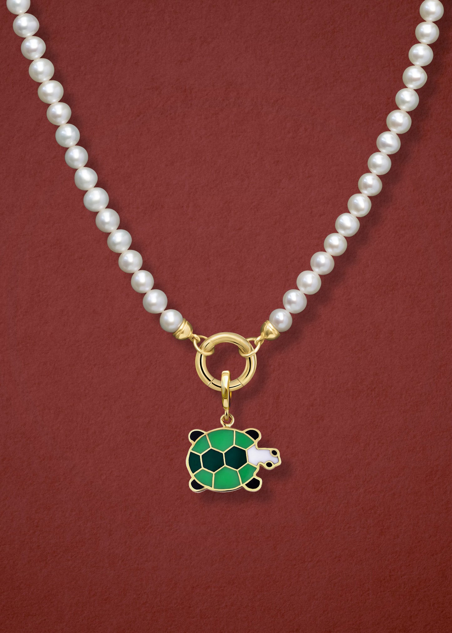 Close-up of the Lustrous Pearl Turtle Treasure Charm Necklace, featuring freshwater pearls, a golden link charm holder, and a turtle treasure charm in 14K solid gold by whywhy NYC.