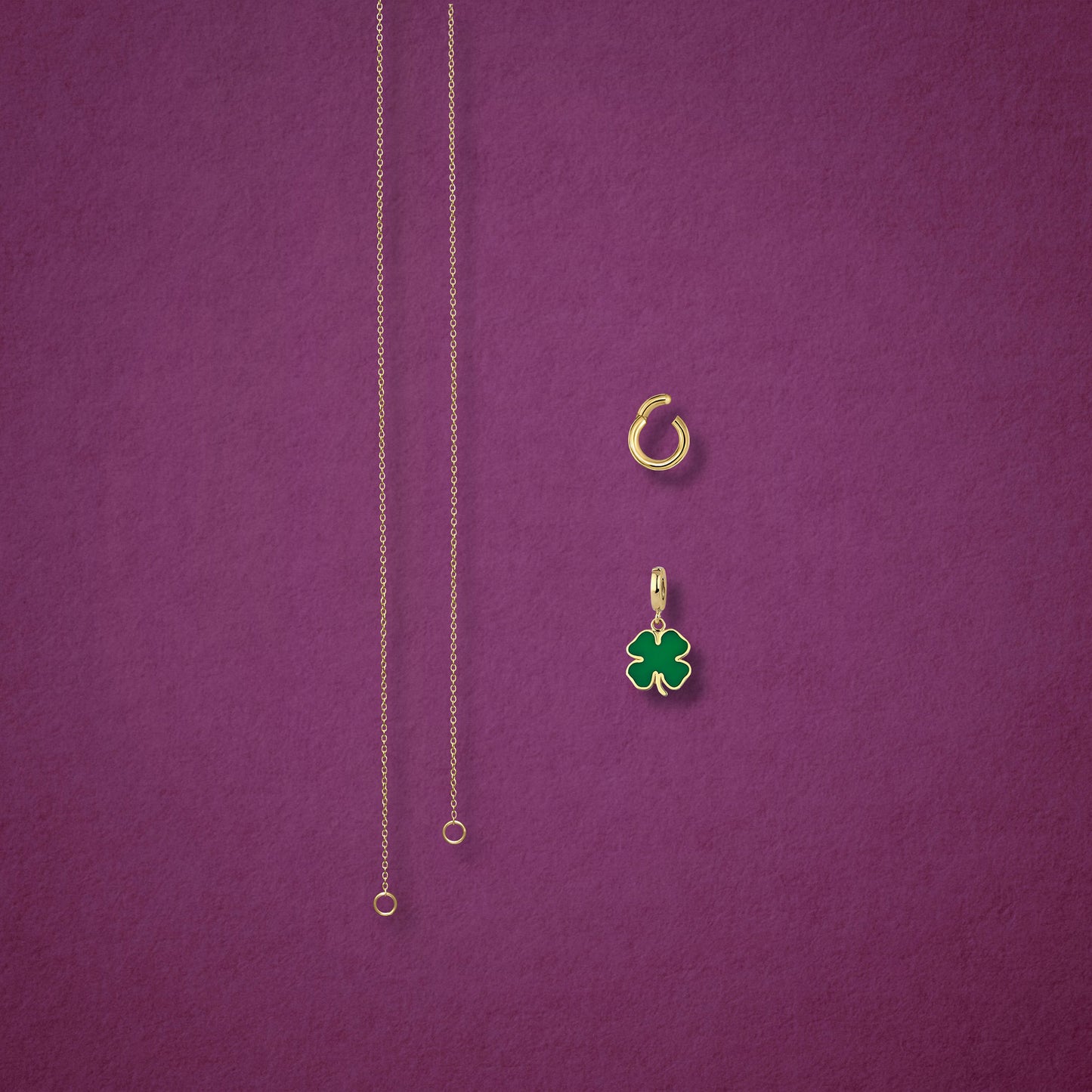 Separated components of the Golden Grace Lucky Clover Charm Necklace, including 14K solid gold cable chain, golden link charm holder, and lucky clover charm with green enamel by whywhy NYC.