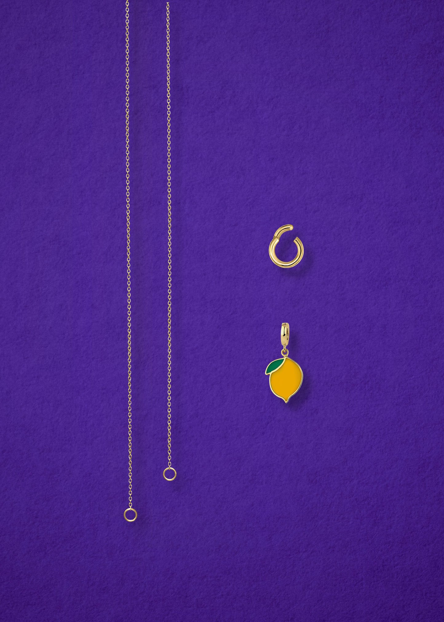 Separated components of the Golden Grace Zesty Lemon Charm Necklace, including 14K solid gold cable chain, golden link charm holder, and zesty lemon charm with yellow enamel by whywhy NYC.
