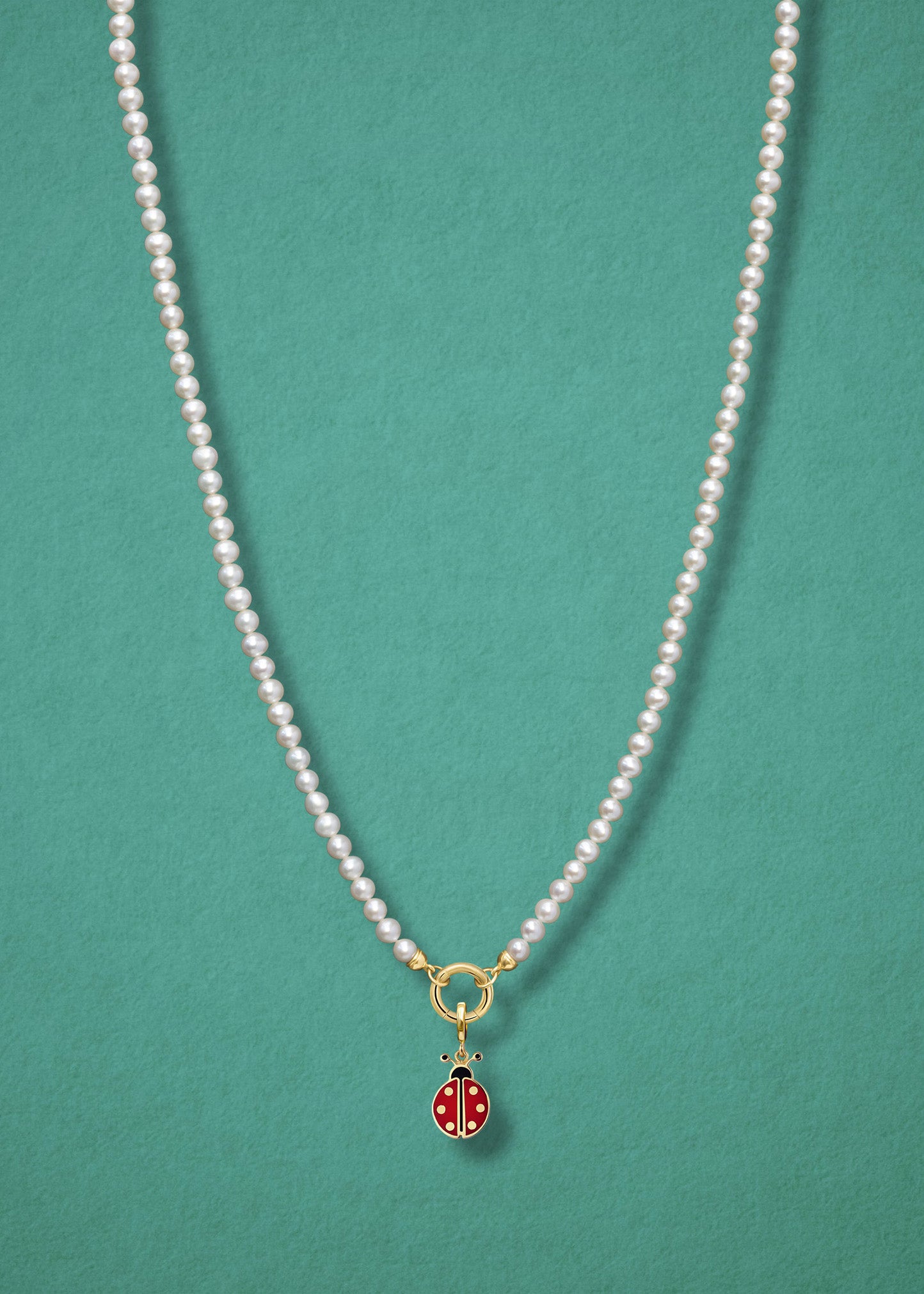 Lucky Ladybird Charm paired with the Lustrous Pearl Charm Necklace by whywhy NYC, featuring 14K solid gold and hand-painted enamel for a playful, elegant look.