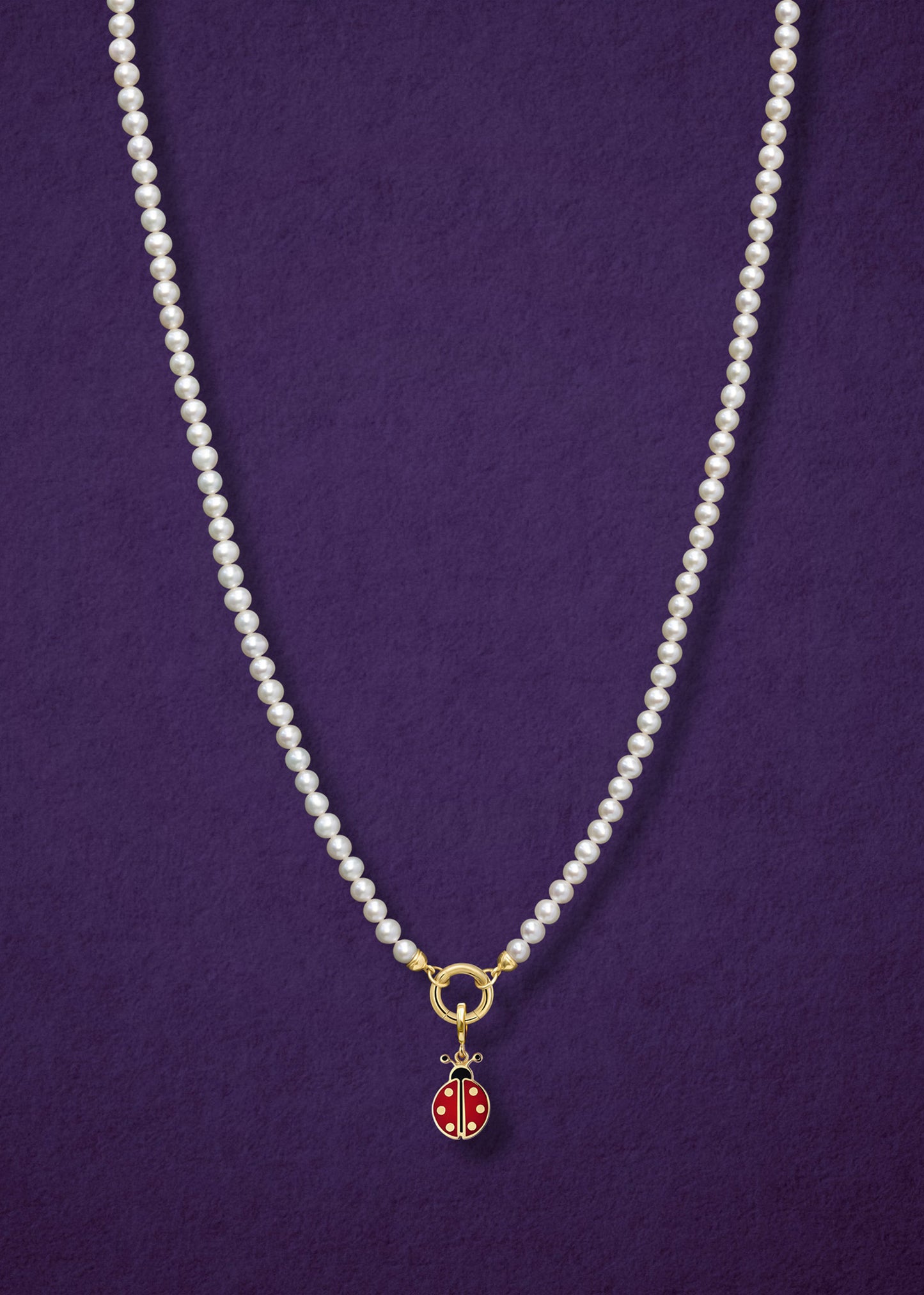 Lustrous Pearl Charm Necklace paired with the Lucky Ladybird Charm by whywhy NYC, featuring 14K solid gold and hand-painted enamel for a playful, elegant look.