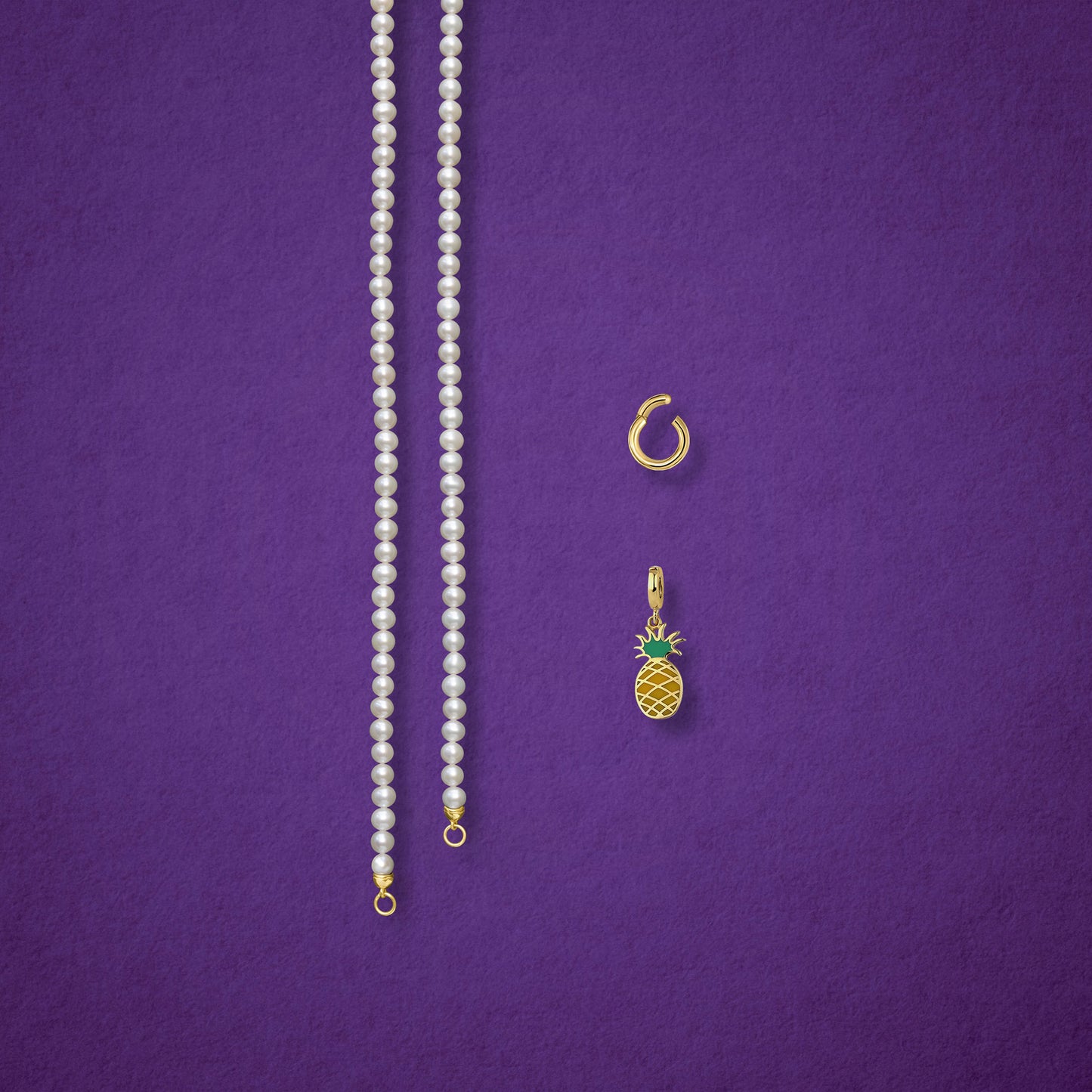 Separated components of the Lustrous Pearl Pineapple Paradise Charm Necklace, including pearl necklace, charm holder, and pineapple paradise charm in 14K solid gold by whywhy NYC.