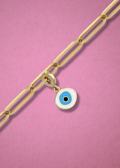 Azure Organic Evil Eye clip-on charm crafted in 14K solid gold with white, blue, and black enamel, shown hanging on a gold chain on a soft pink background.