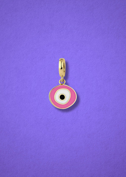 Blush Organic Evil Eye clip-on charm crafted in 14K solid gold with hand-painted pink, white, and black enamel detailing, shown on a lilac background.