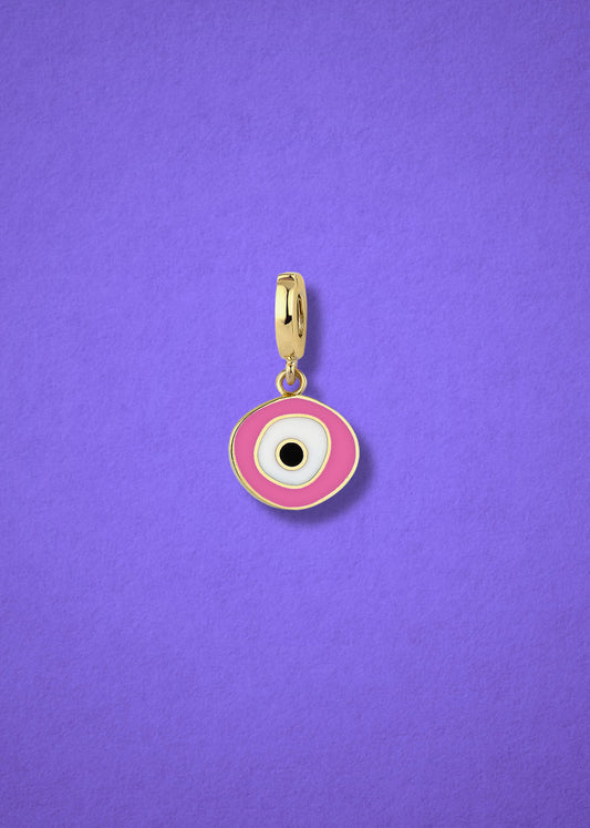 Blush Organic Evil Eye clip-on charm crafted in 14K solid gold with hand-painted pink, white, and black enamel detailing, shown on a lilac background.