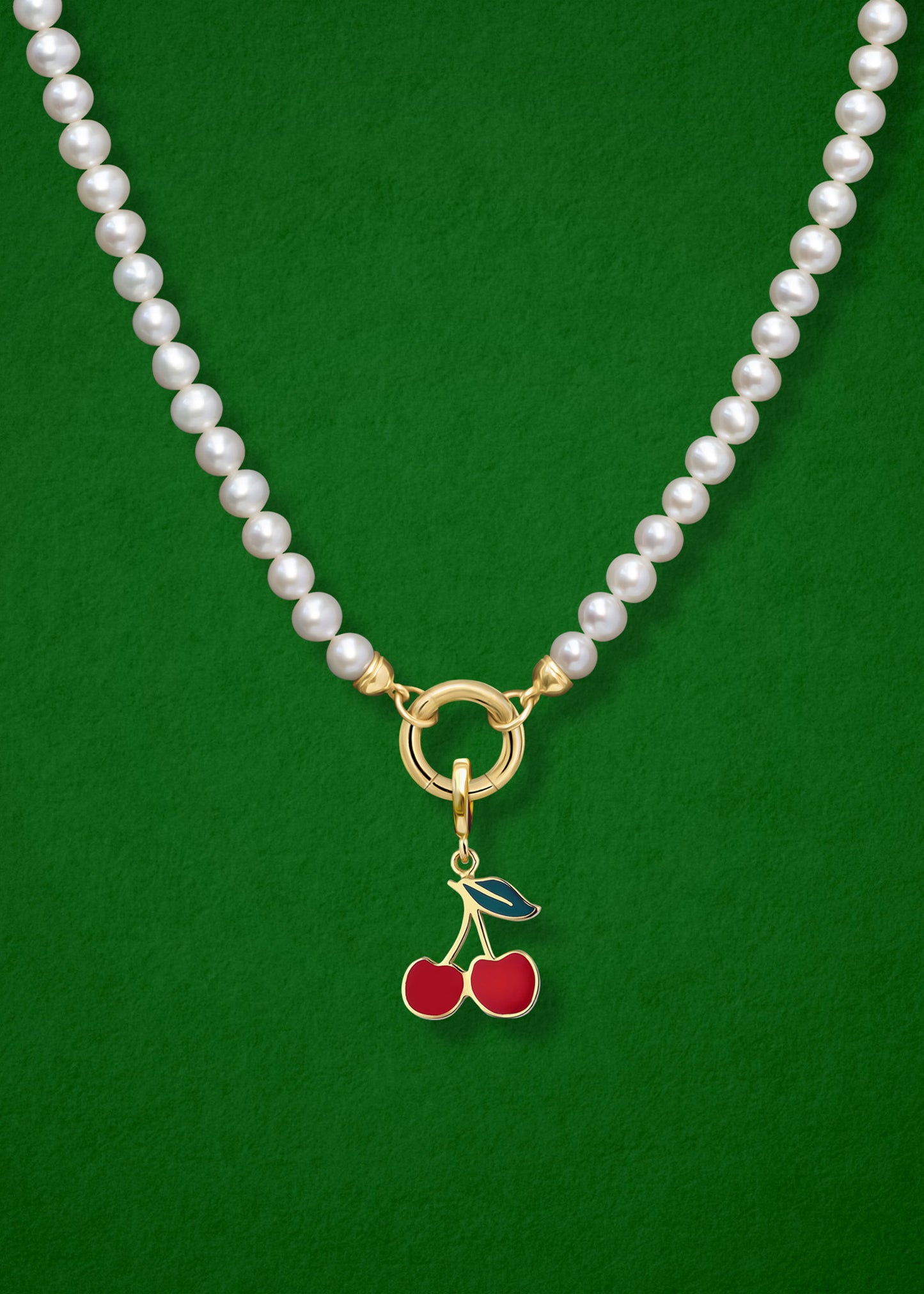 Close-up of the Cherry on Top Charm paired with the Lustrous Pearl Charm Necklace by whywhy NYC, featuring 14K solid gold and freshwater pearls for a whimsical yet elegant look.