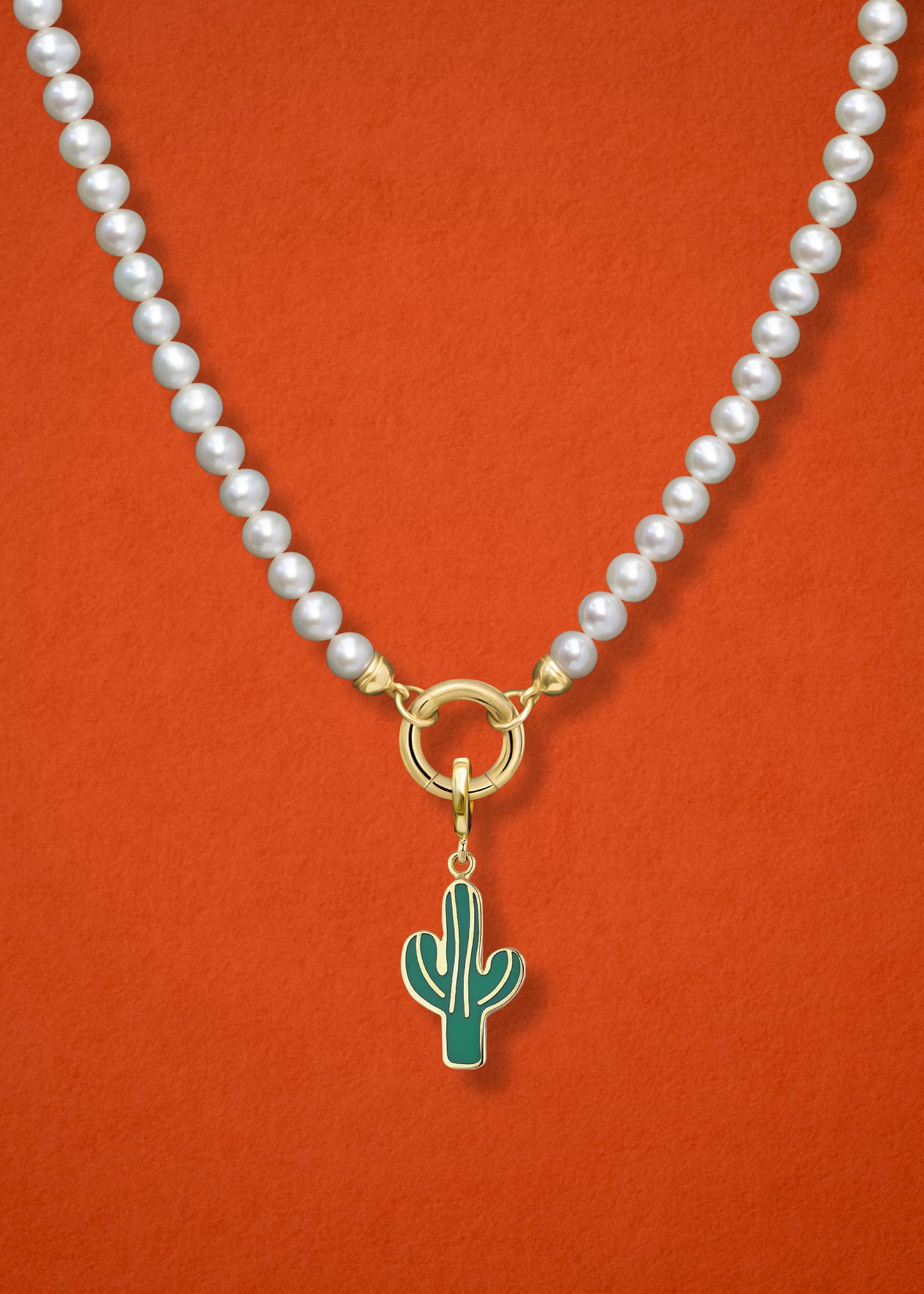 Close-up of the Desert Bloom Charm paired with the Lustrous Pearl Charm Necklace by whywhy NYC, featuring 14K solid gold and freshwater pearls for an elegant yet earthy look.