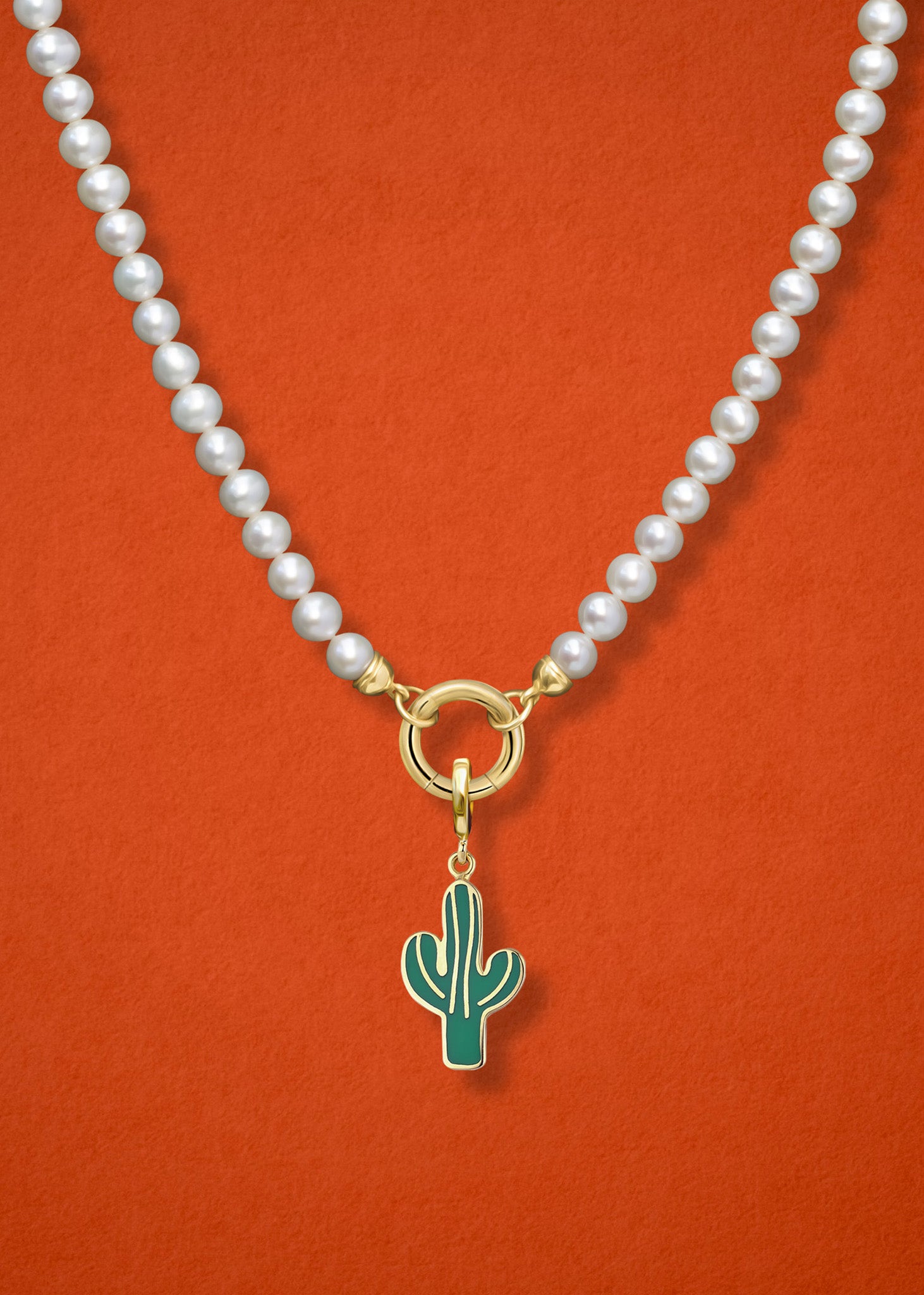 Close-up of the Desert Bloom Charm paired with the Lustrous Pearl Charm Necklace by whywhy NYC, featuring 14K solid gold and freshwater pearls for an elegant yet earthy look.