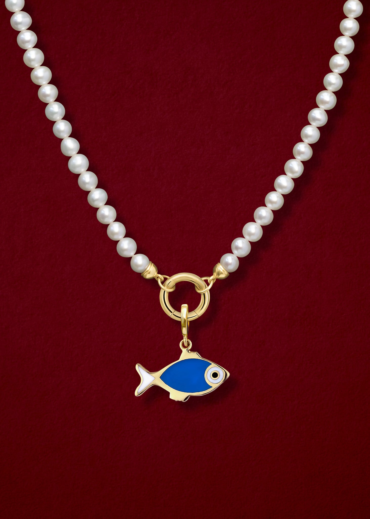 Close-up of the Fishy Wishes Charm paired with the Lustrous Pearl Charm Necklace by whywhy NYC, featuring 14K solid gold and freshwater pearls for an elegant yet playful ocean-inspired look.