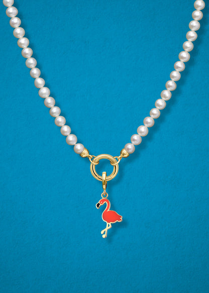 Close-up of the Flamingo Flair Charm paired with the Lustrous Pearl Charm Necklace by whywhy NYC, featuring 14K solid gold and freshwater pearls for an elegant and playful design.