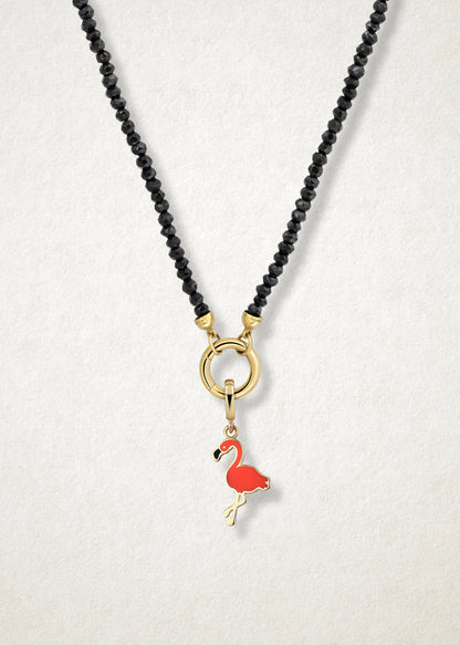 Close-up of the Flamingo Flair Charm paired with the Noir Elegance Charm Necklace by whywhy NYC, featuring black spinel and 14K solid gold for a striking and tropical-inspired look.