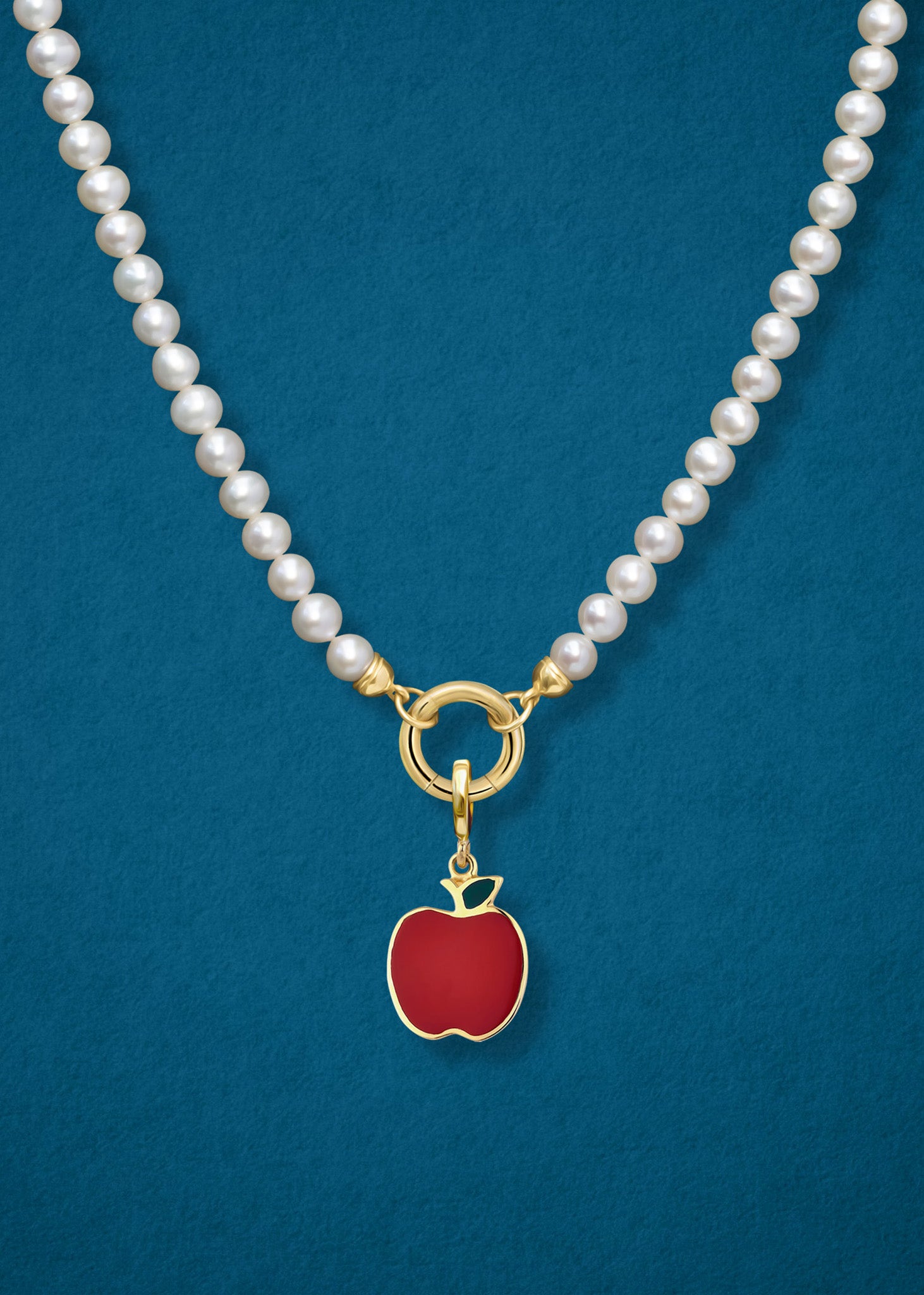 Close-up of the Golden Apple Charm paired with the Lustrous Pearl Charm Necklace by whywhy NYC, featuring 14K solid gold and freshwater pearls for an elegant and playful look.