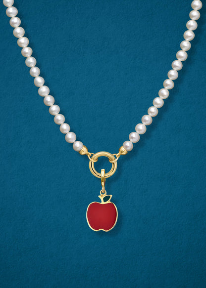 Close-up of the Golden Apple Charm paired with the Lustrous Pearl Charm Necklace by whywhy NYC, featuring 14K solid gold and freshwater pearls for an elegant and playful look.