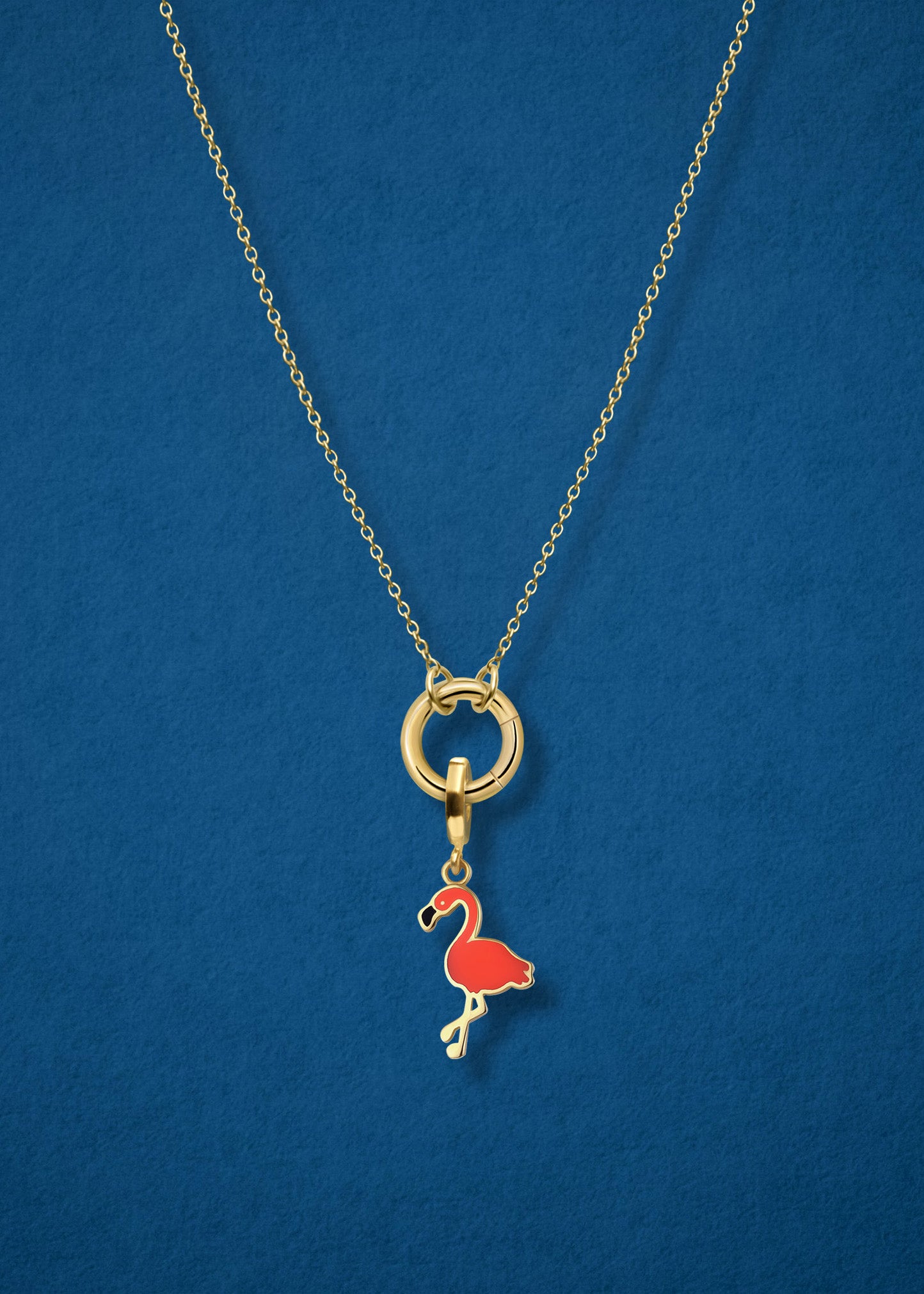 Close-up of the Golden Grace Flamingo Flair Charm Necklace, featuring a 14K solid gold cable chain, a golden charm holder, and a flamingo flair charm with vibrant orange enamel by whywhy NYC.