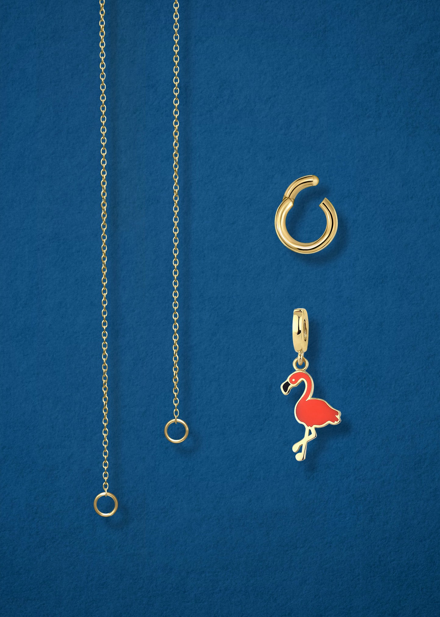 Close-up of the separated Golden Grace Flamingo Flair Charm Necklace components: 14K solid gold cable chain, golden charm holder, and flamingo flair charm with vibrant orange enamel by whywhy NYC.