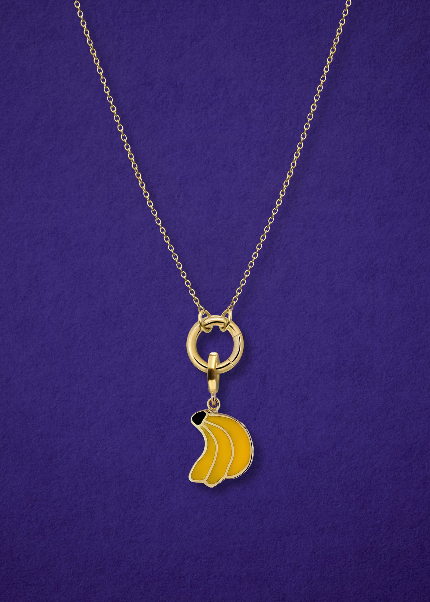 Close-up of the Golden Grace Banana Bliss Charm Necklace, featuring a 14K solid gold cable chain, a golden link charm holder, and a banana bliss charm with yellow enamel by whywhy NYC.