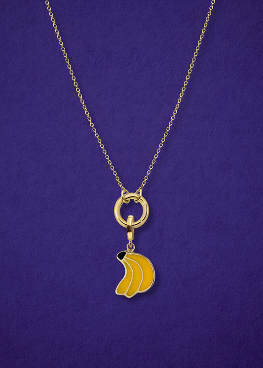 Close-up of the Golden Grace Banana Bliss Charm Necklace, featuring a 14K solid gold cable chain, a golden link charm holder, and a banana bliss charm with yellow enamel by whywhy NYC.