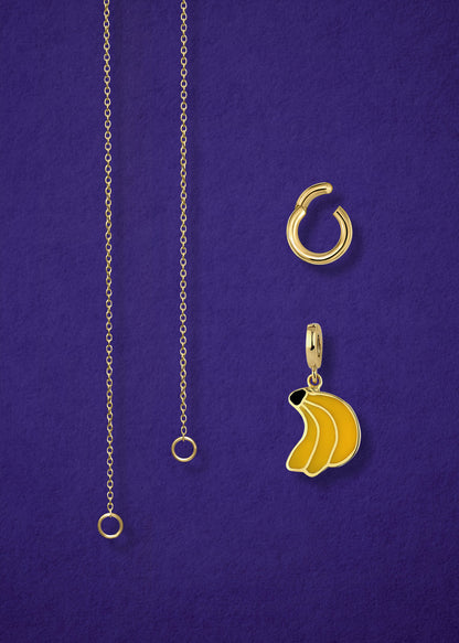 Close-up of the separated Golden Grace Banana Bliss Charm Necklace components: 14K solid gold cable chain, golden link charm holder, and banana bliss charm with yellow enamel by whywhy NYC.