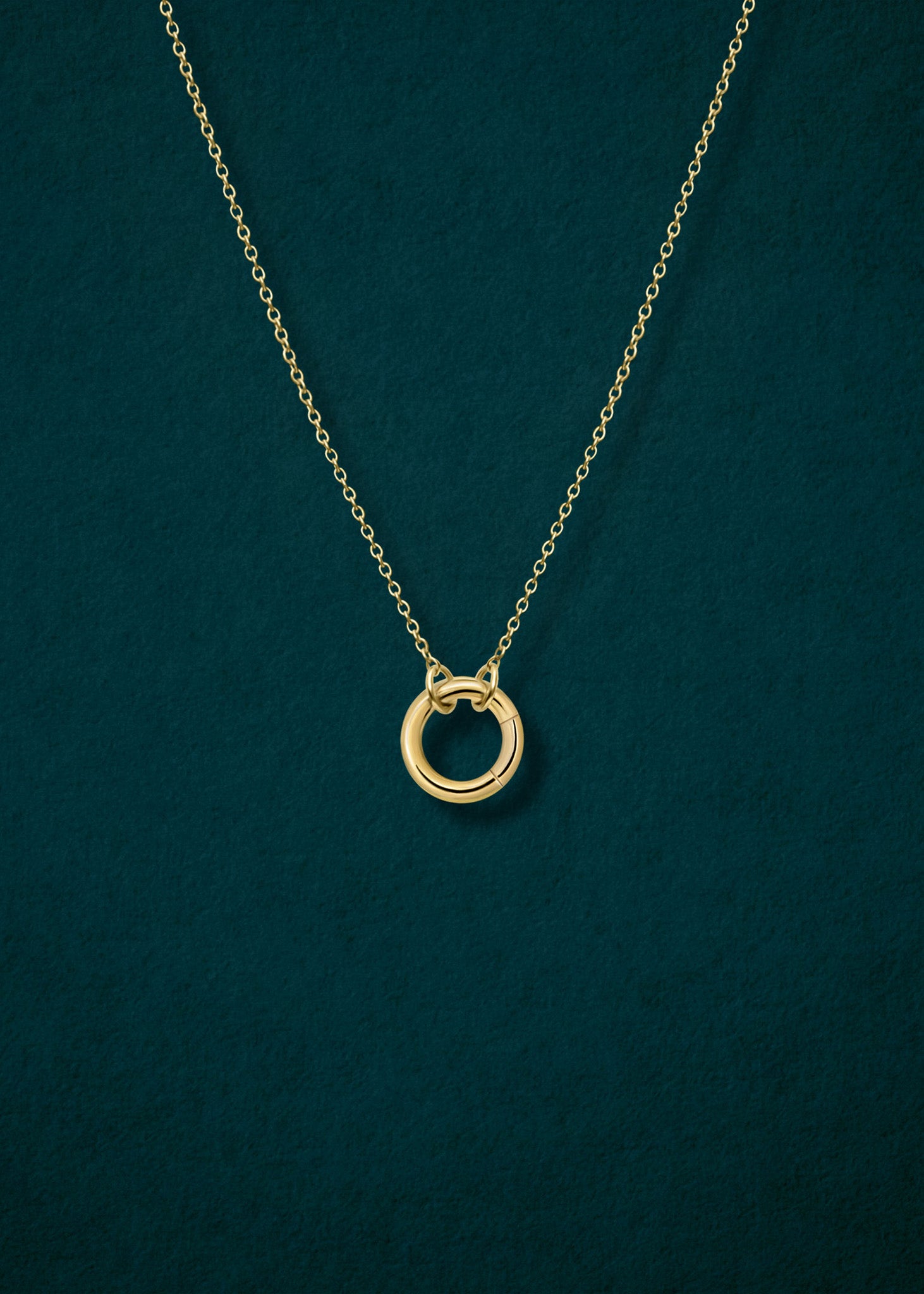 Close-up of 14K solid gold charm holder paired with the Golden Grace Cable Chain by whywhy NYC, showcasing sleek, elegant connections for charm styling.