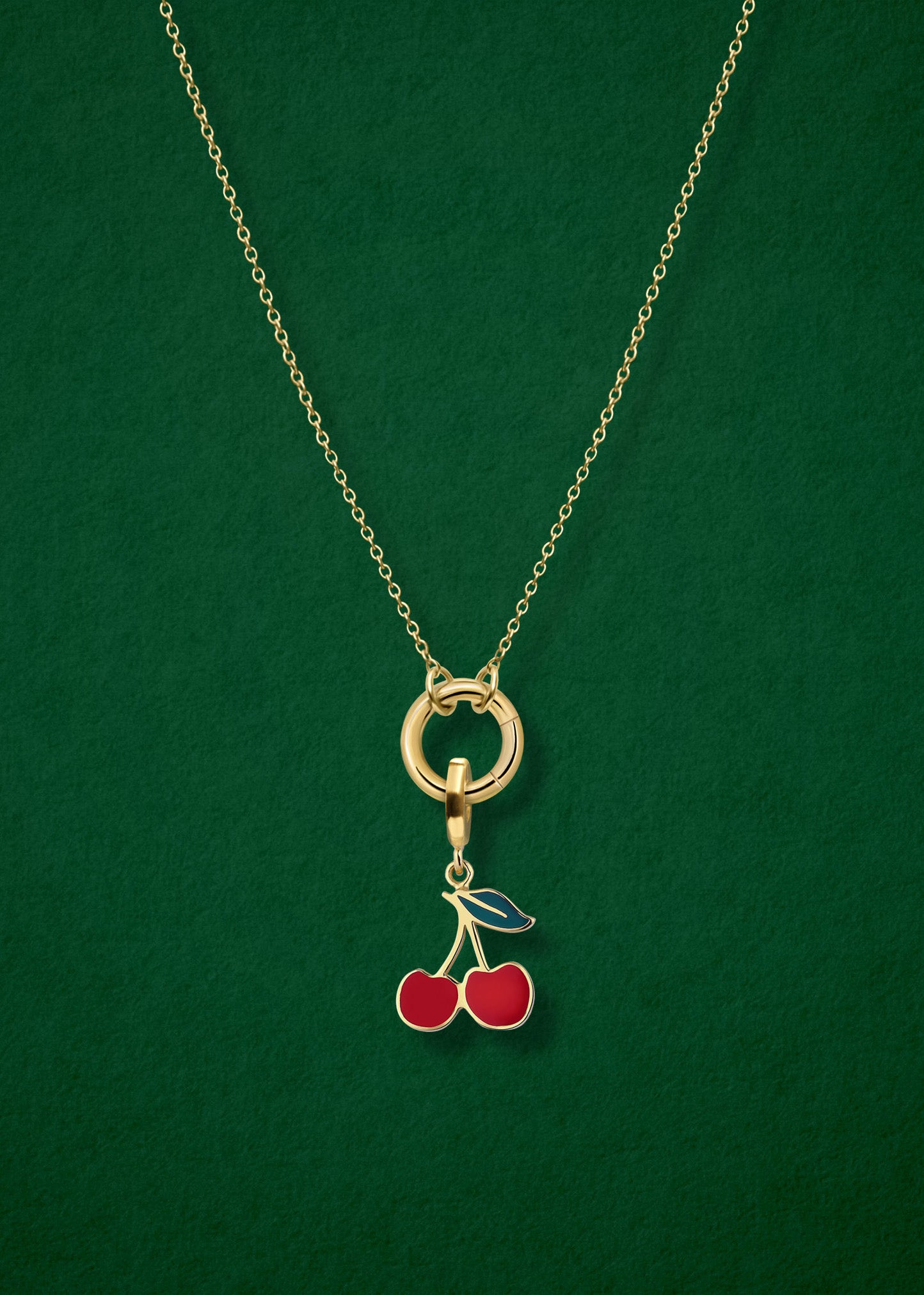 Close-up of the Golden Grace Cherry on Top Charm Necklace, featuring a 14K solid gold cable chain, a golden link charm holder, and a cherry on top charm with red enamel by whywhy NYC.