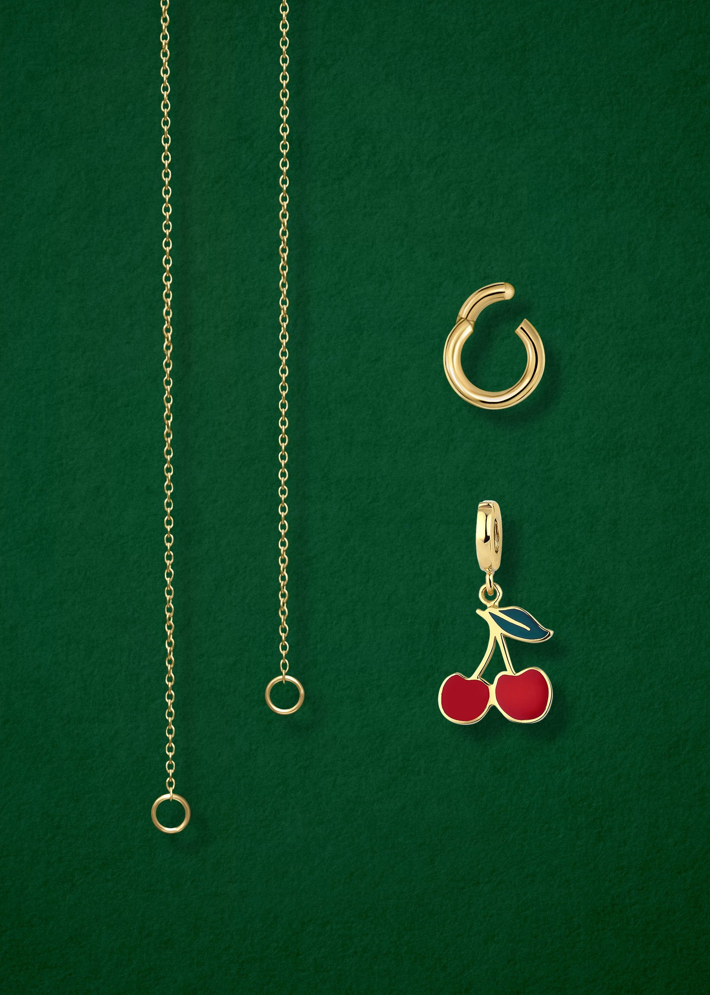 Close-up of the separated Golden Grace Cherry on Top Charm Necklace components: 14K solid gold cable chain, golden link charm holder, and cherry on top charm with red enamel by whywhy NYC.