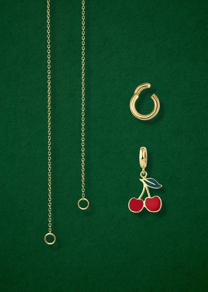 Close-up of the separated Golden Grace Cherry on Top Charm Necklace components: 14K solid gold cable chain, golden link charm holder, and cherry on top charm with red enamel by whywhy NYC.