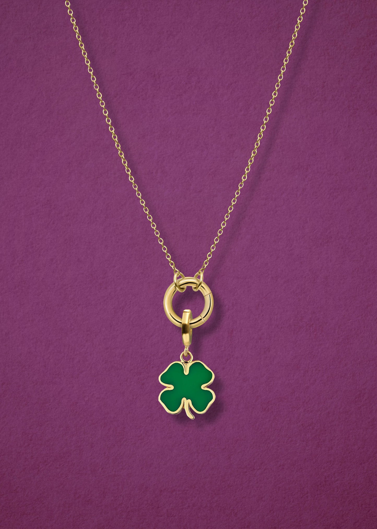 Close-up of the Golden Grace Lucky Clover Charm Necklace, featuring a 14K solid gold cable chain, a golden link charm holder, and a lucky clover charm with green enamel by whywhy NYC.