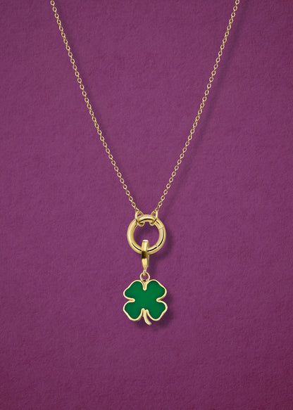 Close-up of the Golden Grace Lucky Clover Charm Necklace, featuring a 14K solid gold cable chain, a golden link charm holder, and a lucky clover charm with green enamel by whywhy NYC.