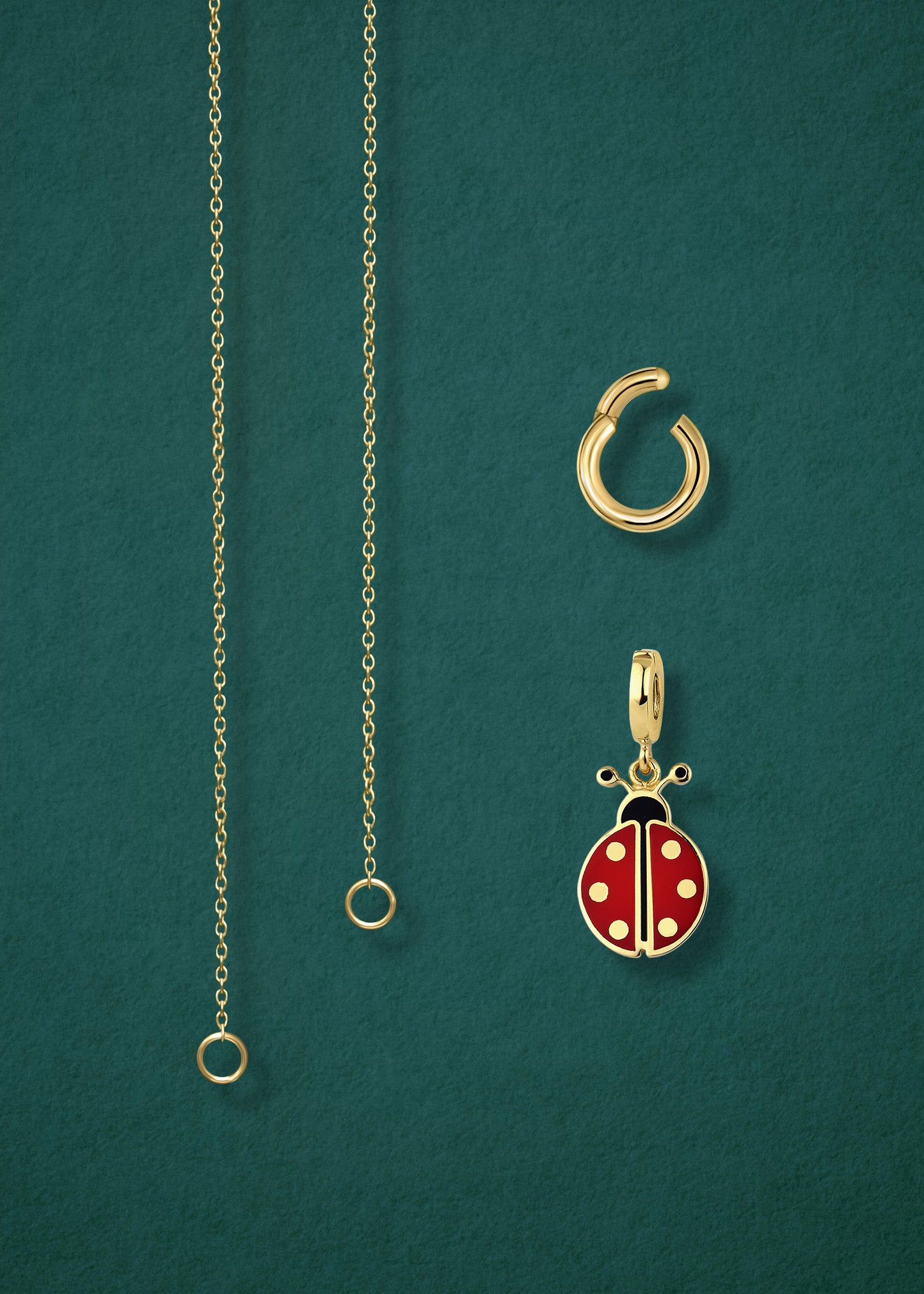 Close-up of the separated Golden Grace Lucky Ladybird Charm Necklace components: 14K solid gold cable chain, golden charm holder, and lucky ladybird charm with red and black enamel by whywhy NYC.