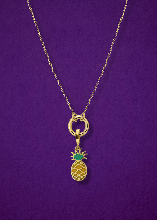 Close-up of the Golden Grace Pineapple Paradise Charm Necklace, featuring a 14K solid gold cable chain, a golden link charm holder, and a pineapple paradise charm with green enamel by whywhy NYC.