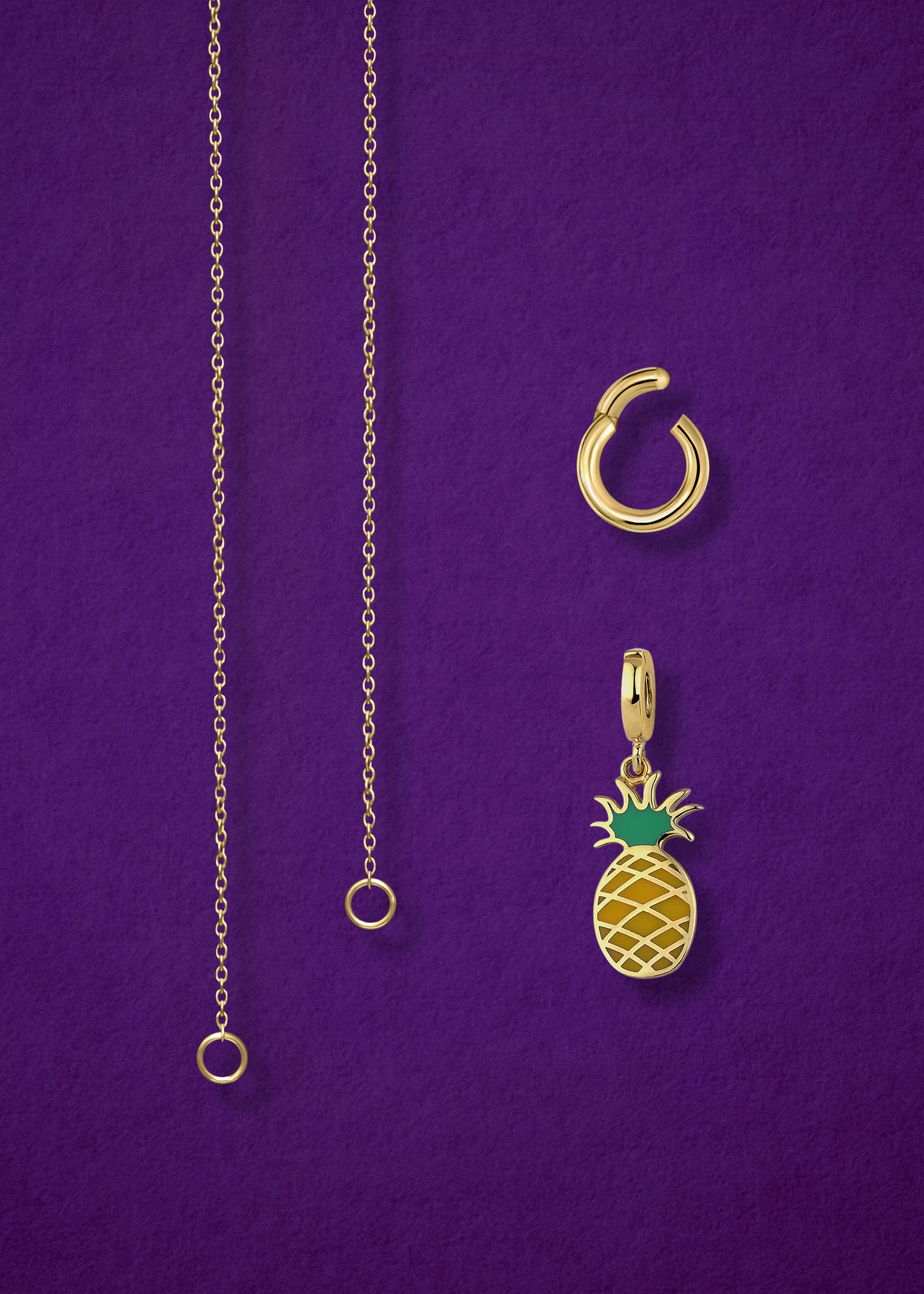 Close-up of the separated Golden Grace Pineapple Paradise Charm Necklace components: 14K solid gold cable chain, golden link charm holder, and pineapple paradise charm with green enamel by whywhy NYC.