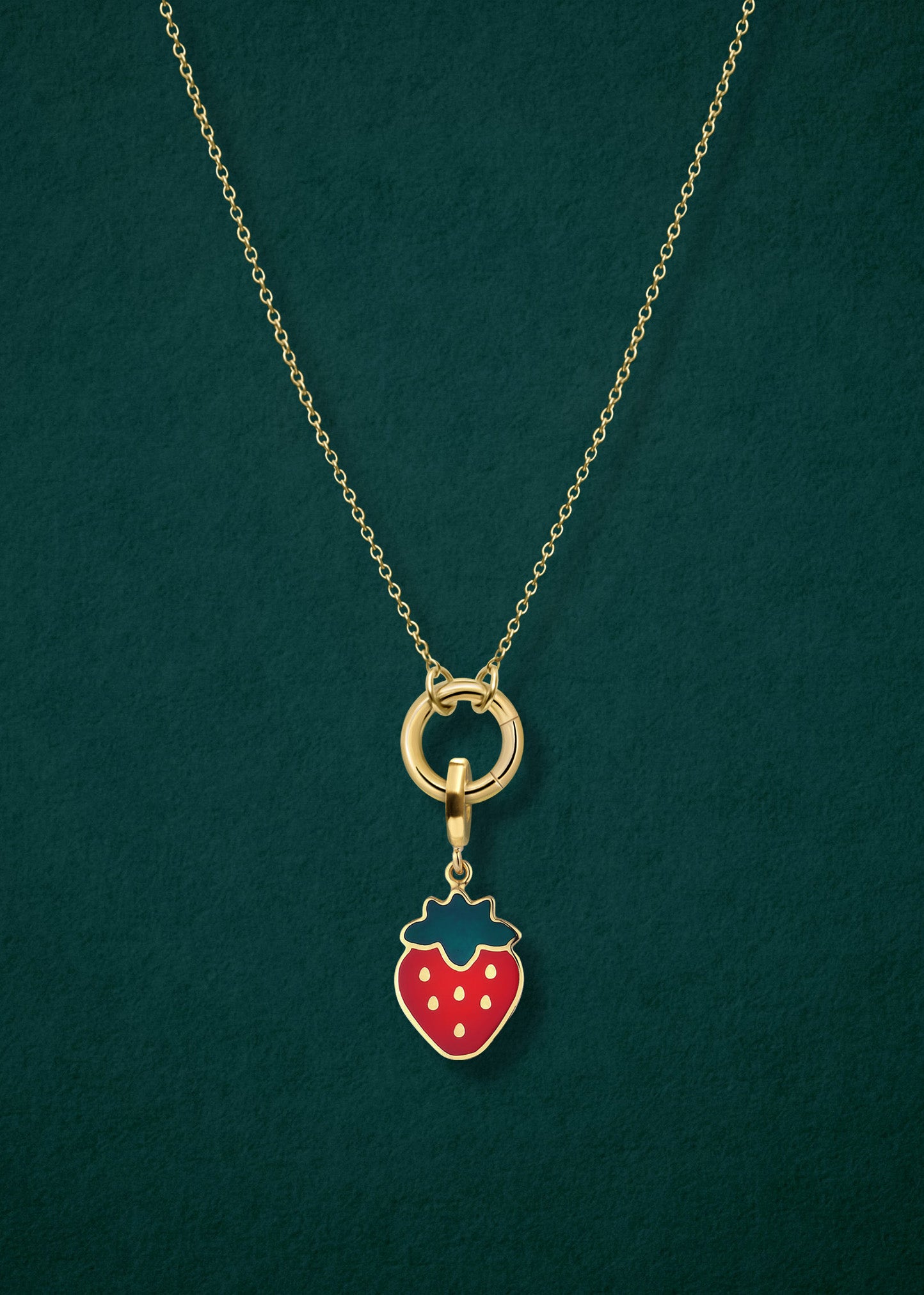 Close-up of the Golden Grace Sweet Strawberry Charm Necklace, featuring a 14K solid gold cable chain, a golden link charm holder, and a sweet strawberry charm with red enamel by whywhy NYC.