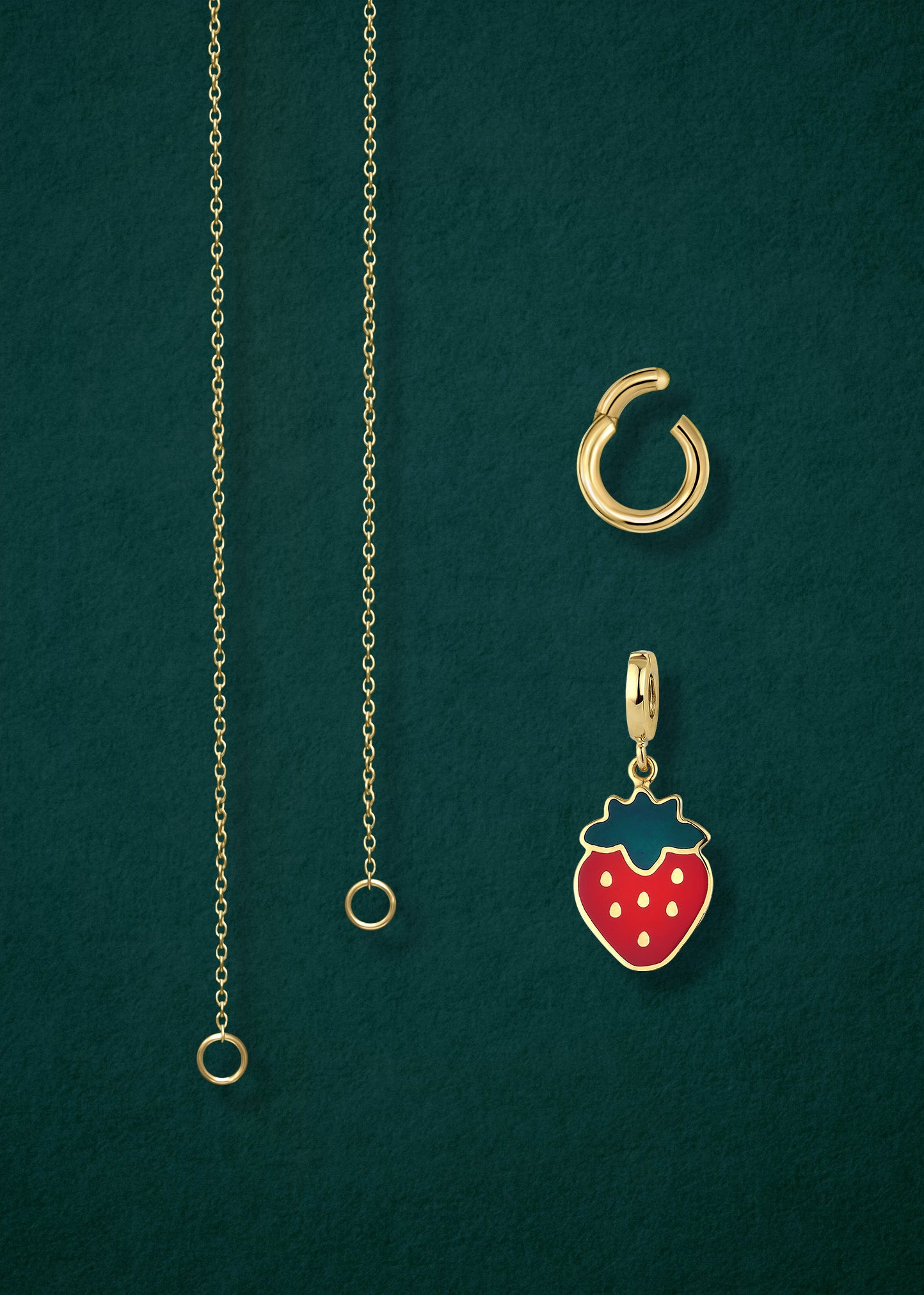 Close-up of the separated Golden Grace Sweet Strawberry Charm Necklace components: 14K solid gold cable chain, golden link charm holder, and sweet strawberry charm with red enamel by whywhy NYC.