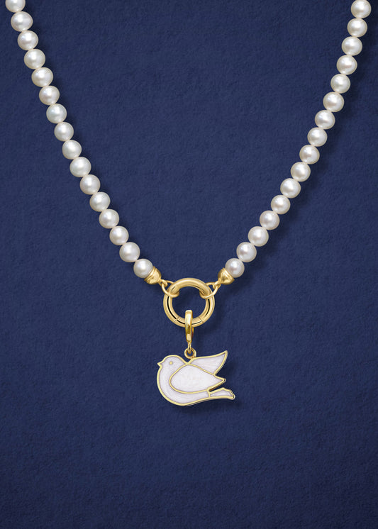 Close-up of the Lustrous Pearl Dove of Hope Charm Necklace, featuring freshwater pearls, a golden link charm holder, and a dove of hope charm in 14K solid gold by whywhy NYC.