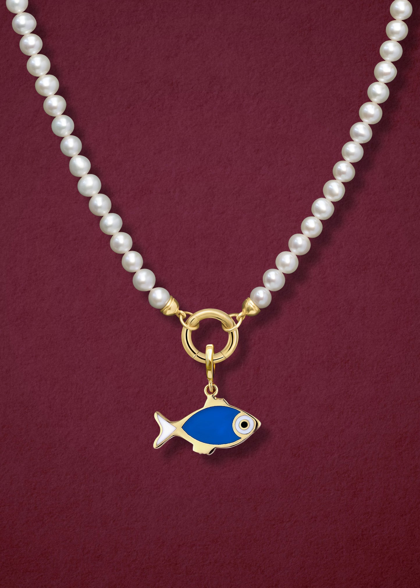 Close-up of the Lustrous Pearl Fishy Wishes Charm Necklace, featuring freshwater pearls, a golden link charm holder, and a fishy wishes charm in 14K solid gold by whywhy NYC.