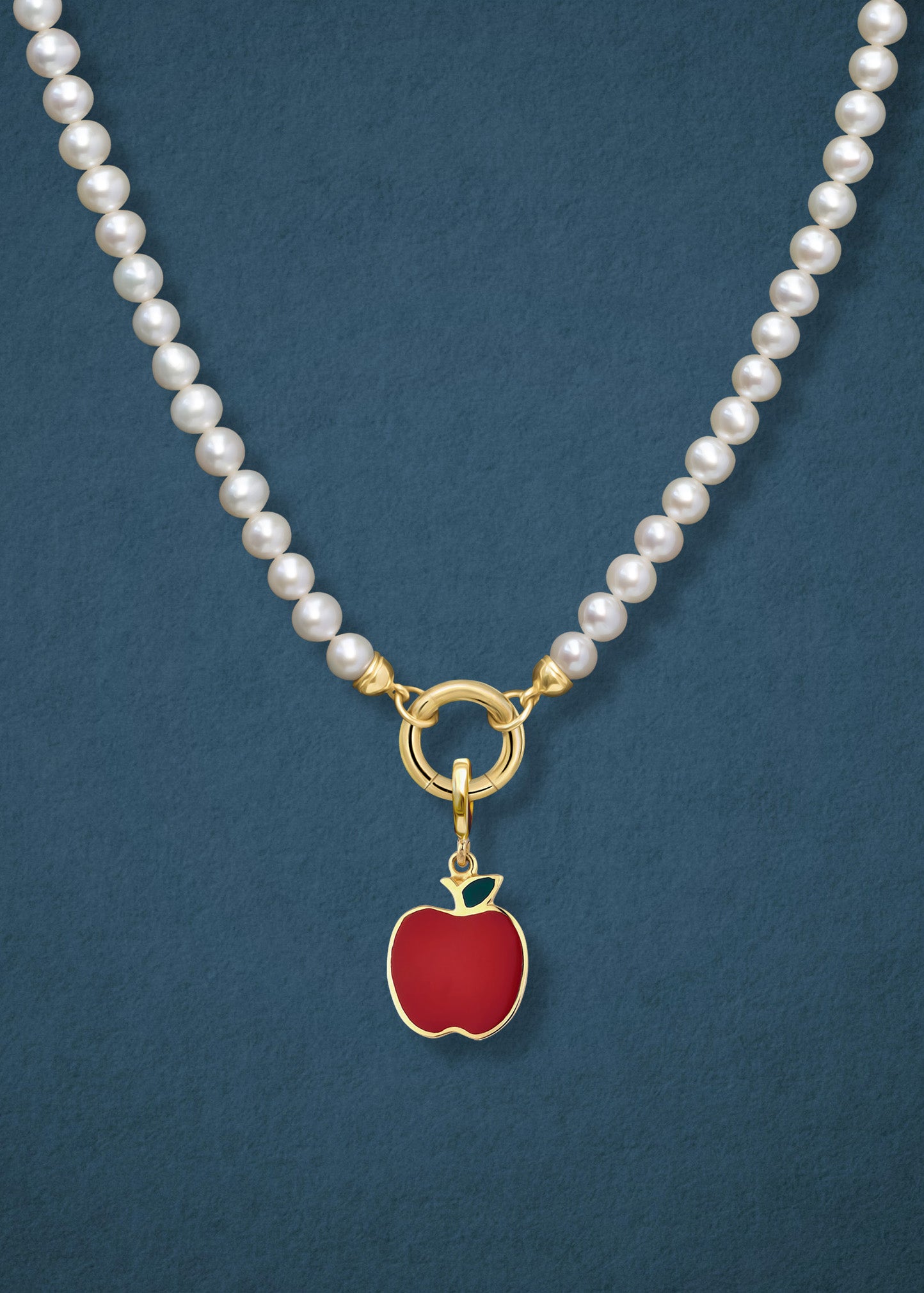 Close-up of the Lustrous Pearl Golden Apple of NYC Charm Necklace, featuring freshwater pearls, a golden link charm holder, and a golden apple charm in 14K solid gold by whywhy NYC.