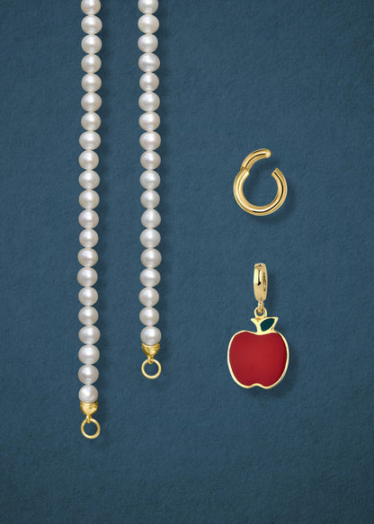 Close-up of the separated Lustrous Pearl Golden Apple of NYC Charm Necklace components: pearl necklace, golden link charm holder, and golden apple charm in 14K solid gold by whywhy NYC.