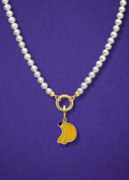 Close-up of the Lustrous Pearl Banana Bliss Charm Necklace, featuring freshwater pearls, a golden link charm holder, and a banana bliss charm in 14K solid gold by whywhy NYC.