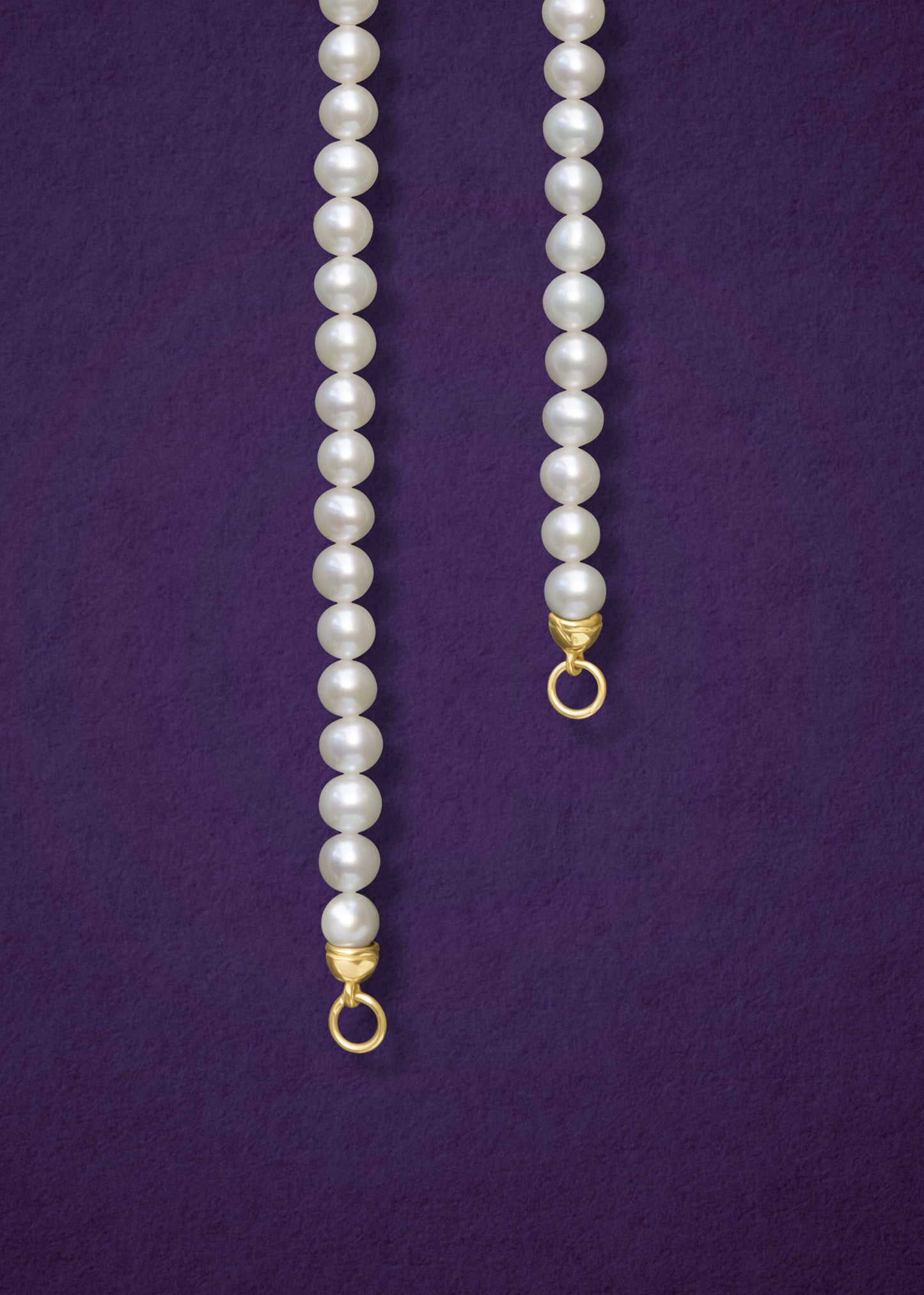 Close-up of the Lustrous Pearl Charm Necklace by whywhy NYC, featuring 3.5mm freshwater pearls and a 14K solid gold clasp for an elegant look.