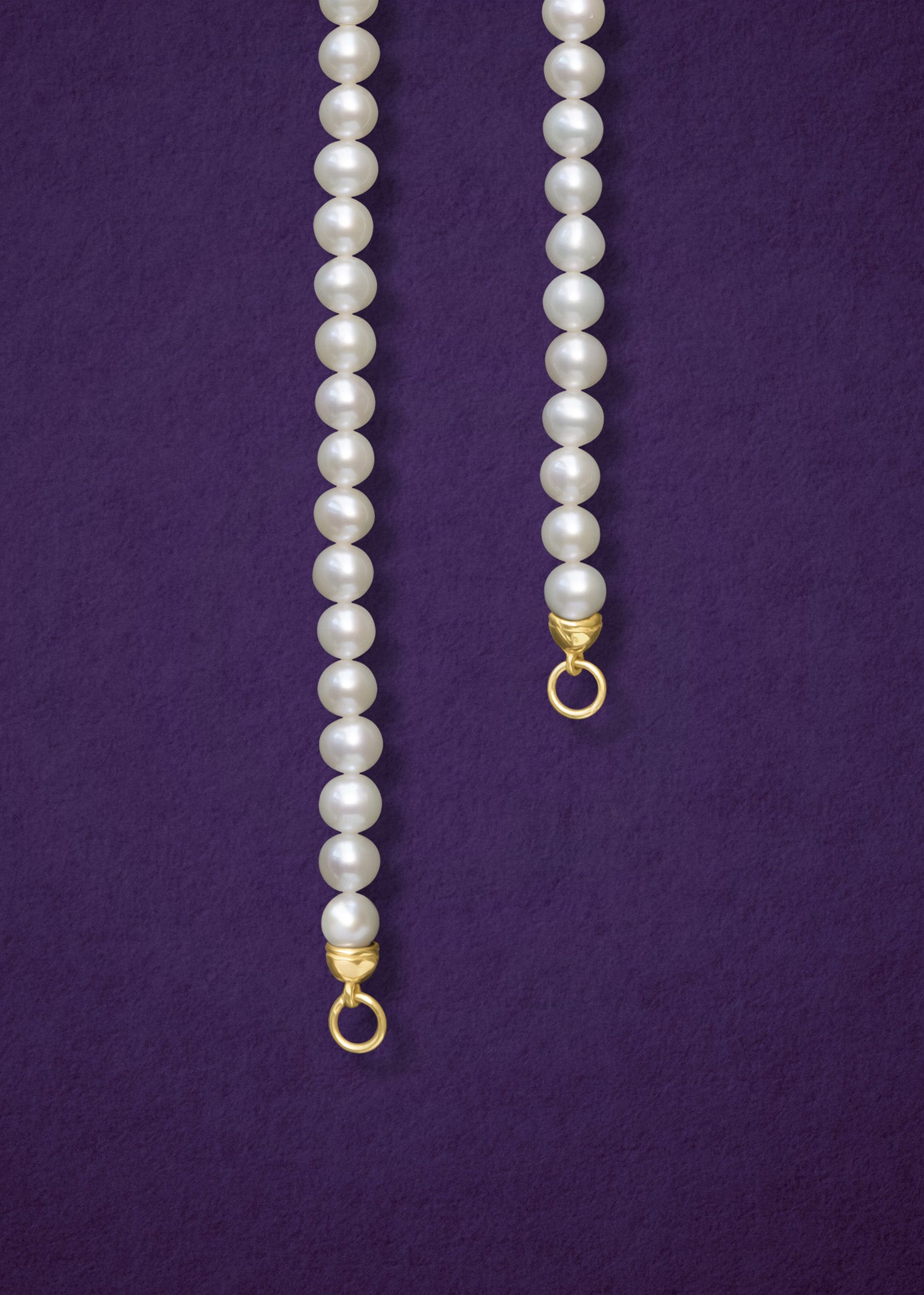 Close-up of the Lustrous Pearl Charm Necklace by whywhy NYC, featuring 3.5mm freshwater pearls and a 14K solid gold clasp for an elegant look.