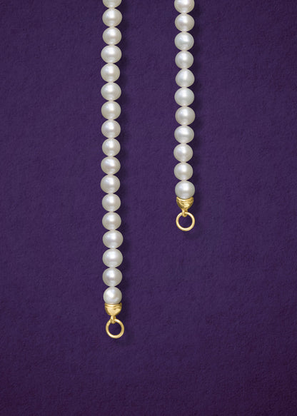 Close-up of the Lustrous Pearl Charm Necklace by whywhy NYC, featuring 3.5mm freshwater pearls and a 14K solid gold clasp for an elegant look.