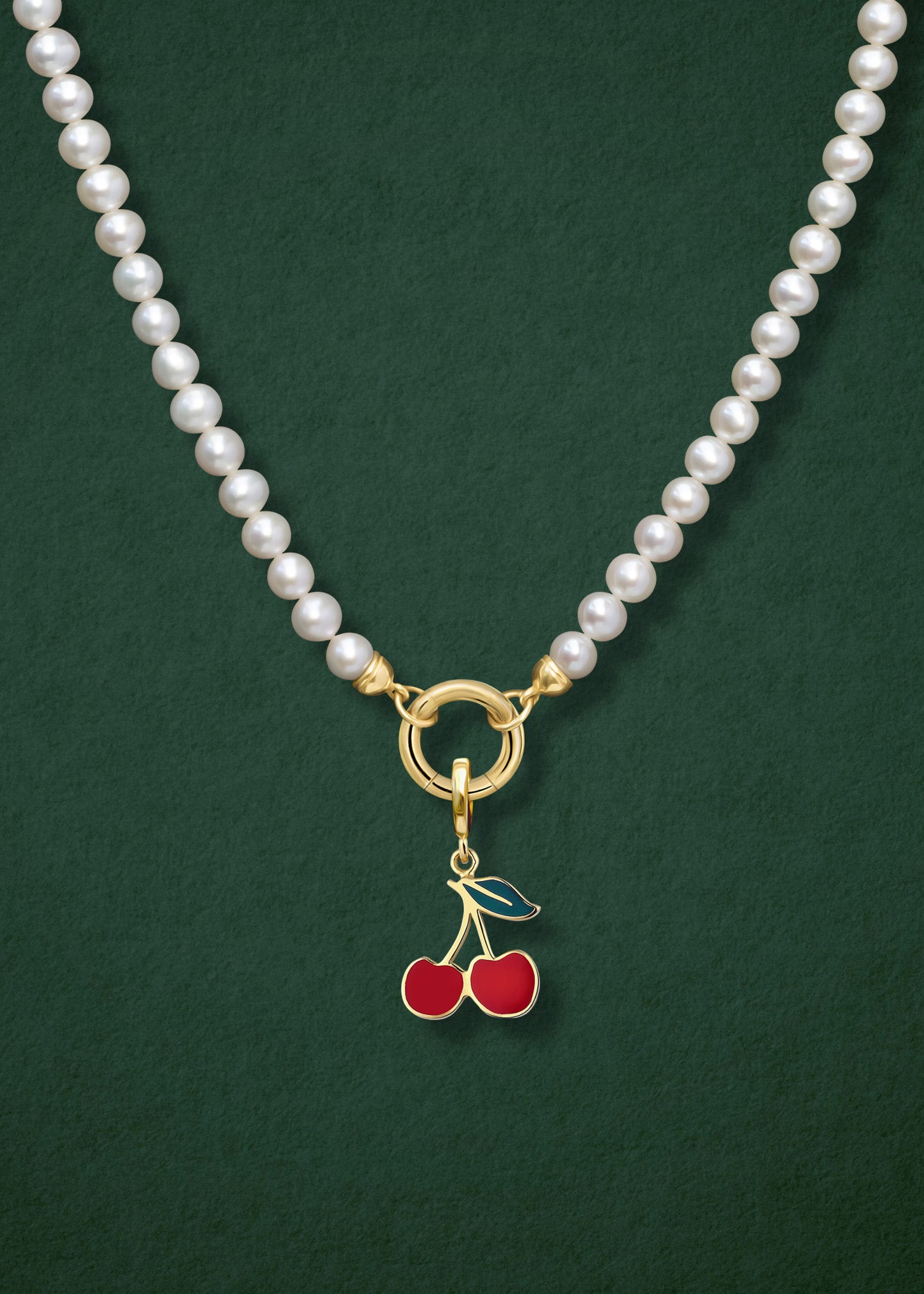 Close-up of the Lustrous Pearl Cherry on Top Charm Necklace, featuring freshwater pearls, a golden link charm holder, and a cherry on top charm in 14K solid gold by whywhy NYC.