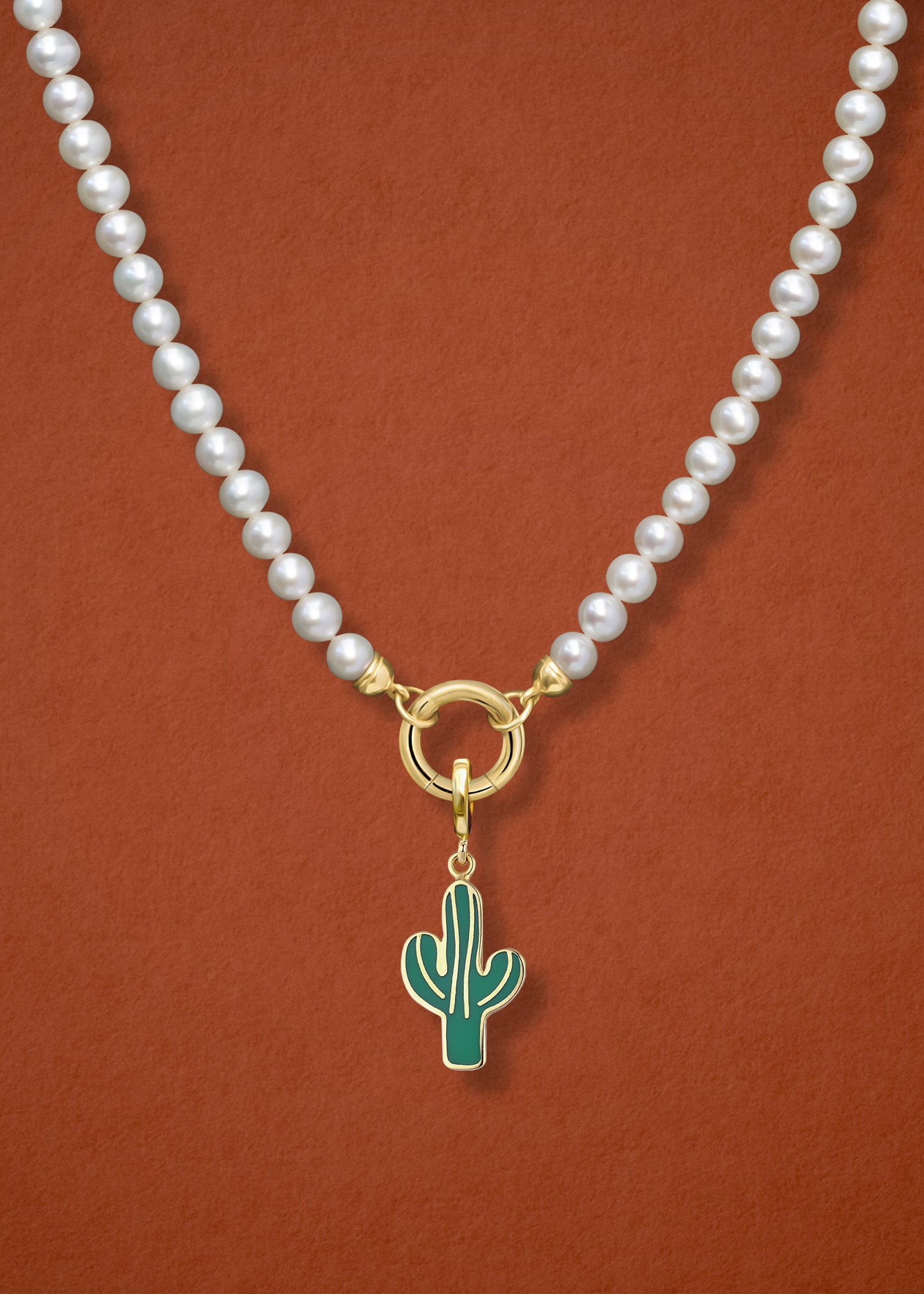 Close-up of the Lustrous Pearl Desert Bloom Charm Necklace, featuring freshwater pearls, a golden link charm holder, and a desert bloom charm in 14K solid gold by whywhy NYC.