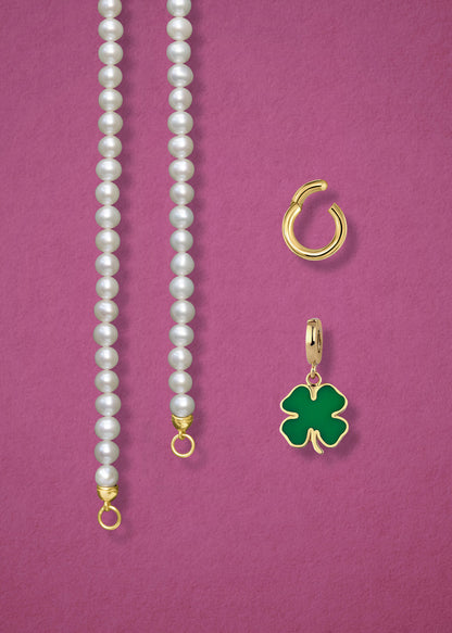 Close-up of the separated Lustrous Pearl Lucky Clover Charm Necklace components: pearl necklace, golden link charm holder, and lucky clover charm in 14K solid gold by whywhy NYC.