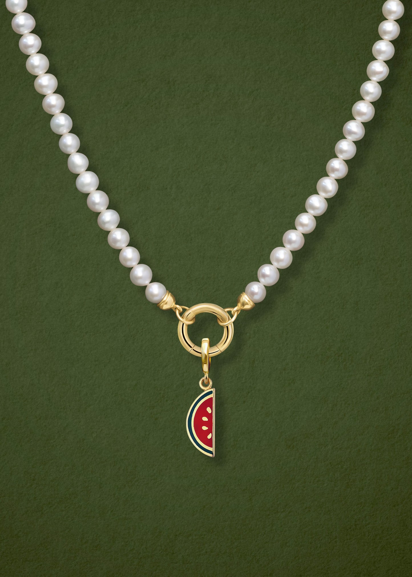 Close-up of the Lustrous Pearl Watermelon Wonder Charm Necklace, featuring freshwater pearls, a golden link charm holder, and a watermelon wonder charm in 14K solid gold by whywhy NYC.